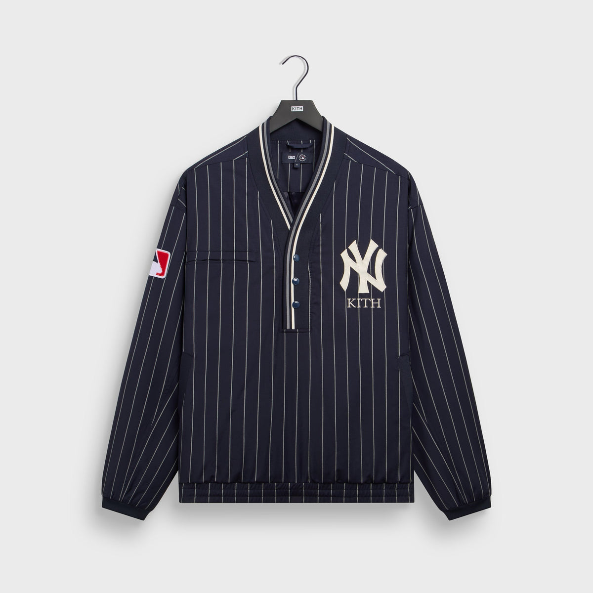Navy pinstripe Kith for New York Yankees Tropical Wool Raffi pullover with V-neck placket and NY Kith logo, front flat lay