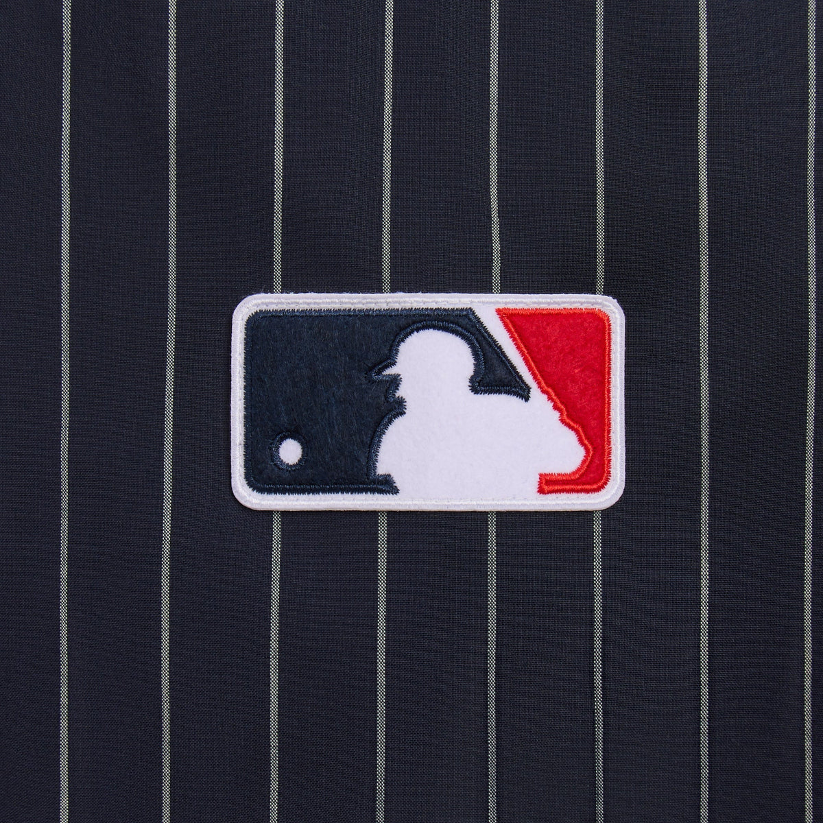 Close-up of MLB American League patch on navy pinstripe Tropical Wool Raffi pullover