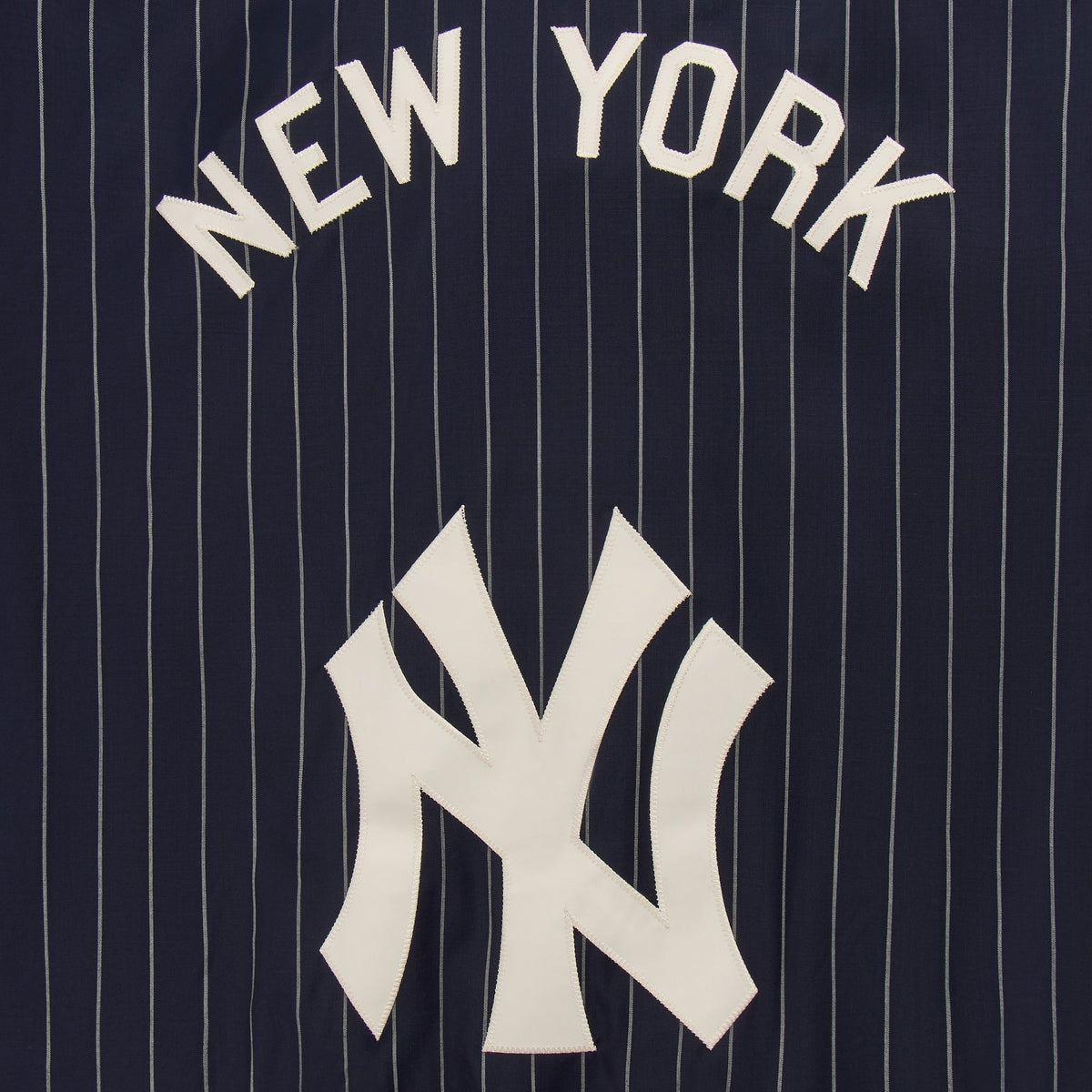 Close-up of New York and NY logo appliqué on the back of the pinstripe Raffi pullover