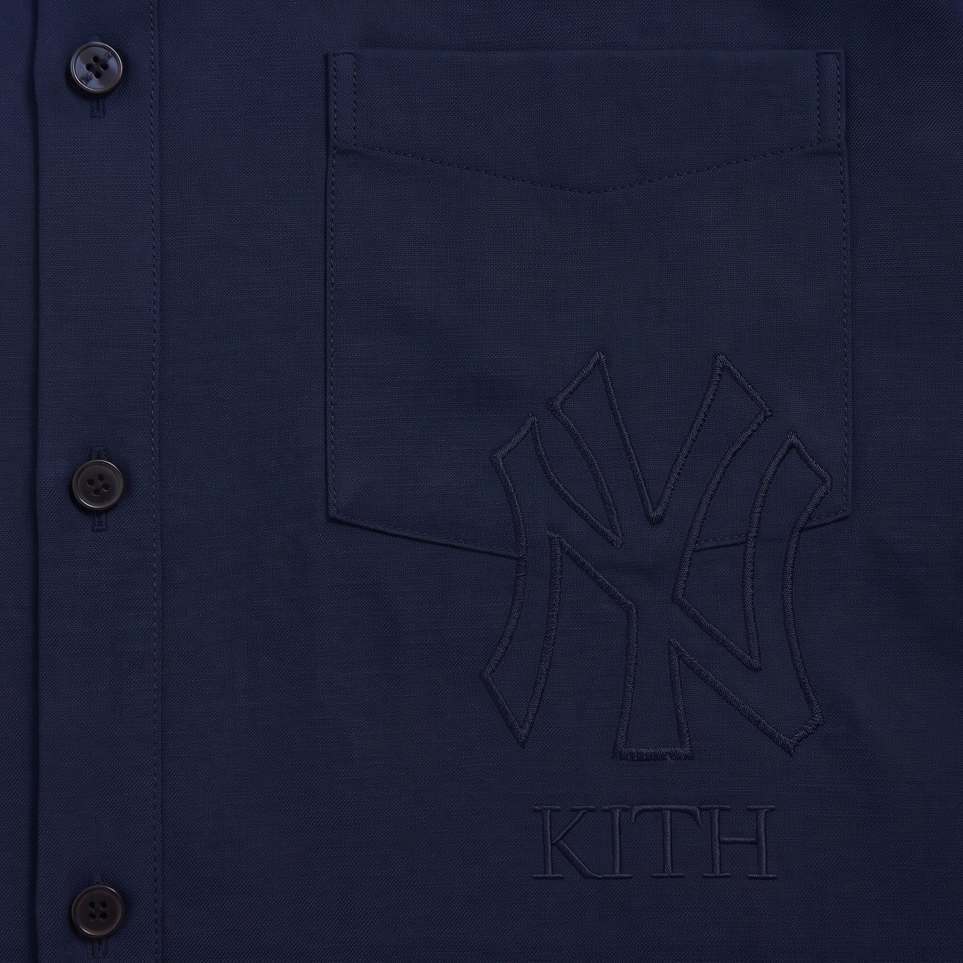 Close-up of tonal embroidered NY Yankees and Kith logo on navy Flannel Deon overshirt pocket