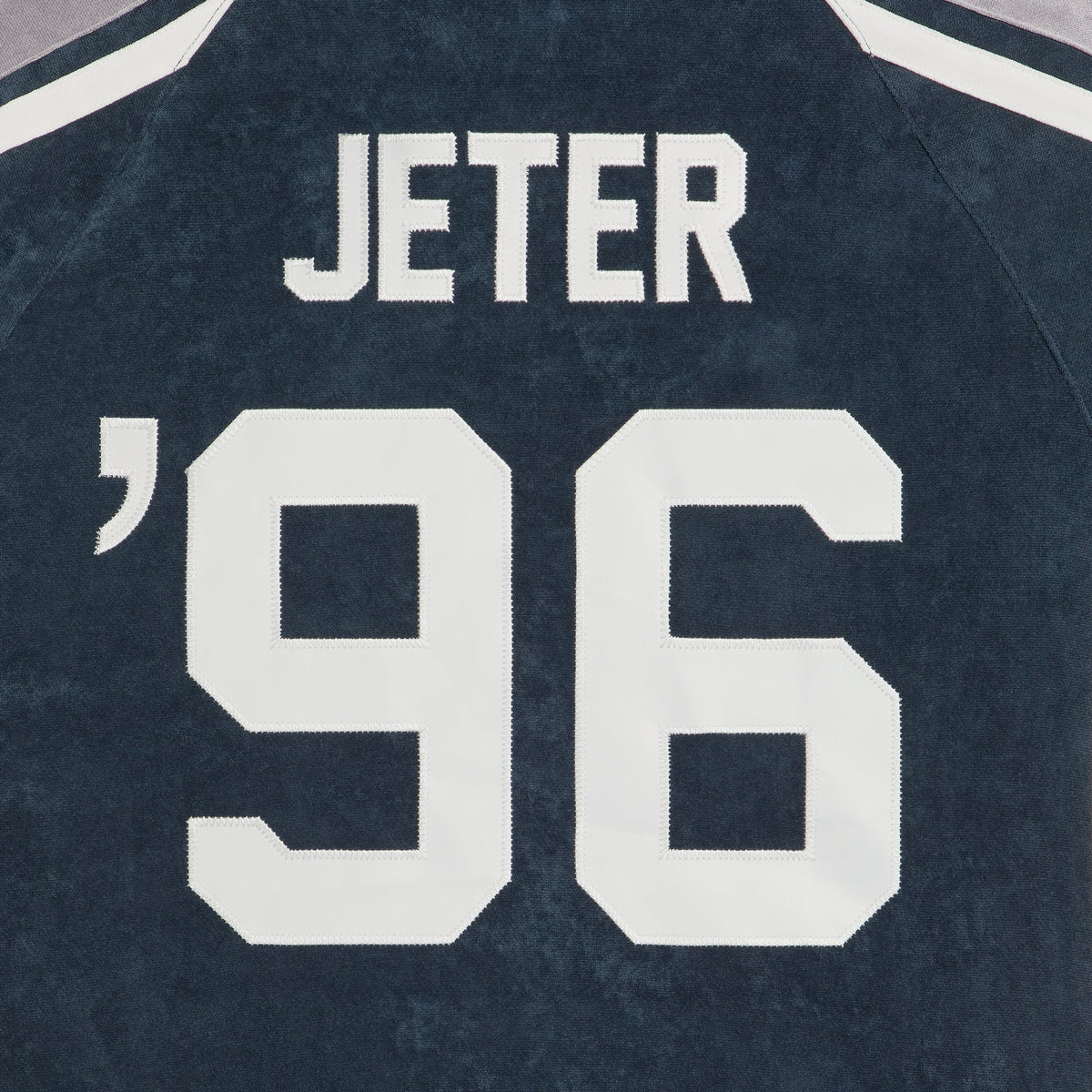 Close-up of Jeter 96 embroidered lettering on the back of navy jersey shirt