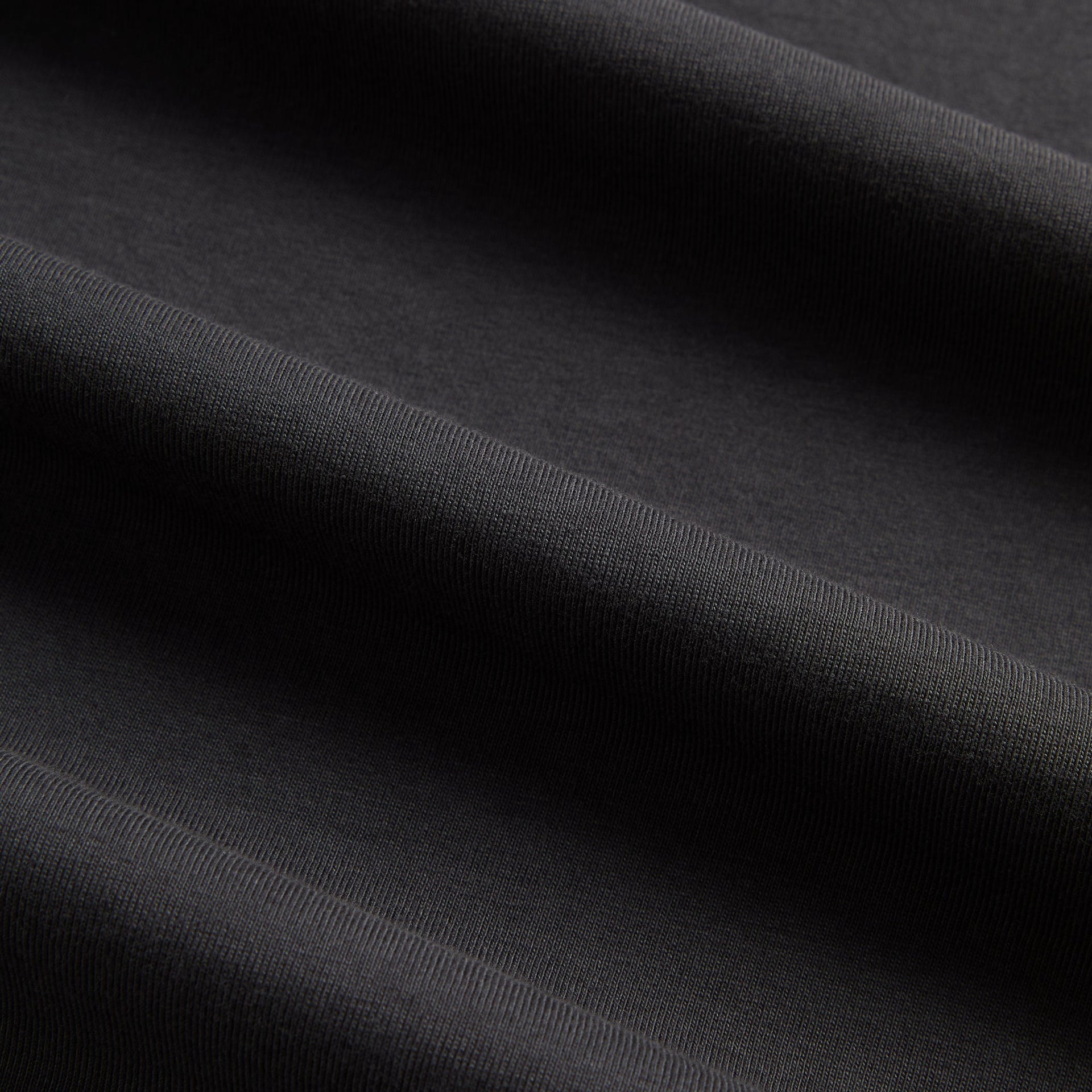 Close-up of the black cotton fabric texture on the Kith LAX tee