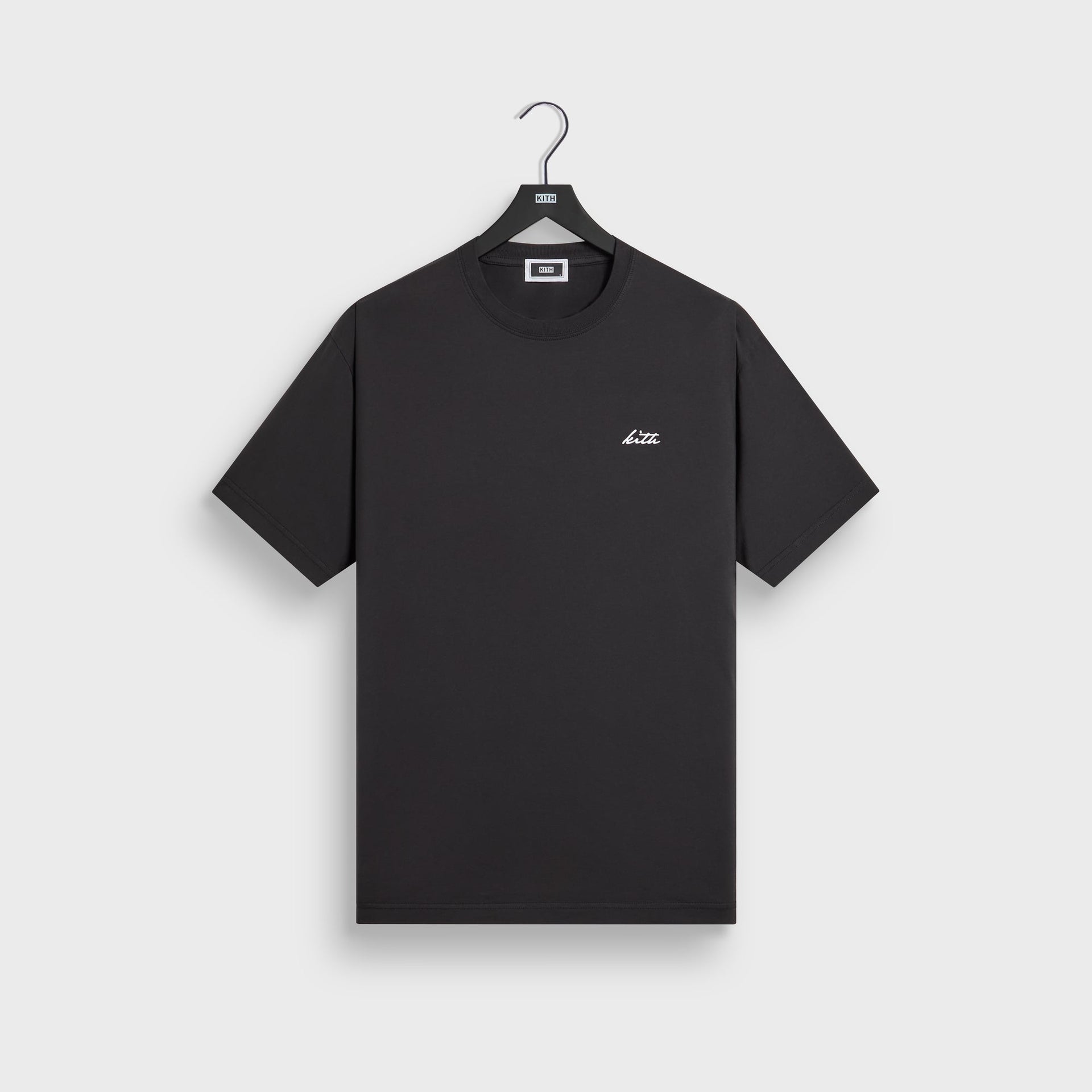 Kith LAX tee in black cotton, front flat lay on hanger