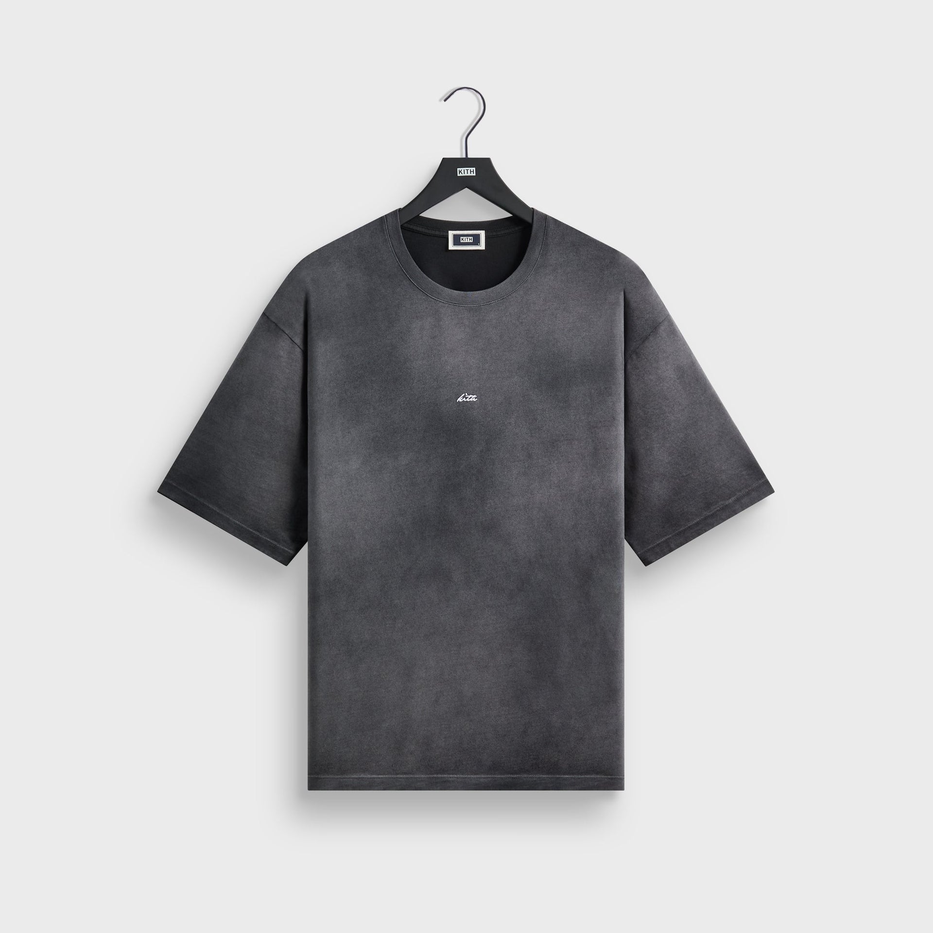 Kith Jones tee in faded black cotton, front flat lay on hanger