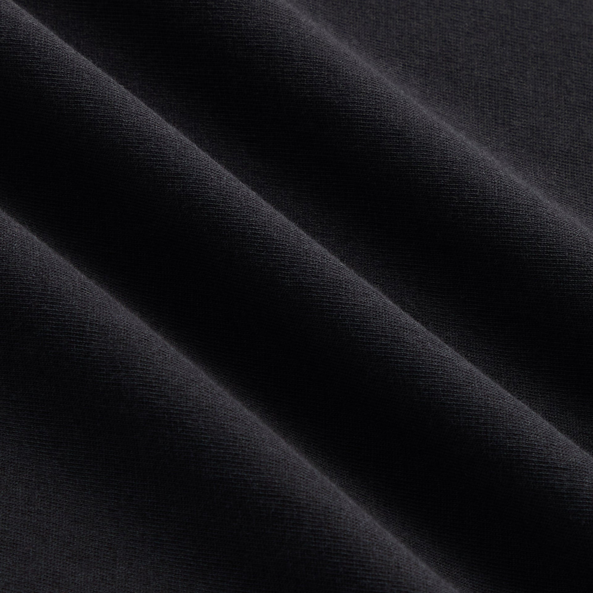 Close-up of the black cotton fabric texture on the Kith Albie crewneck tee