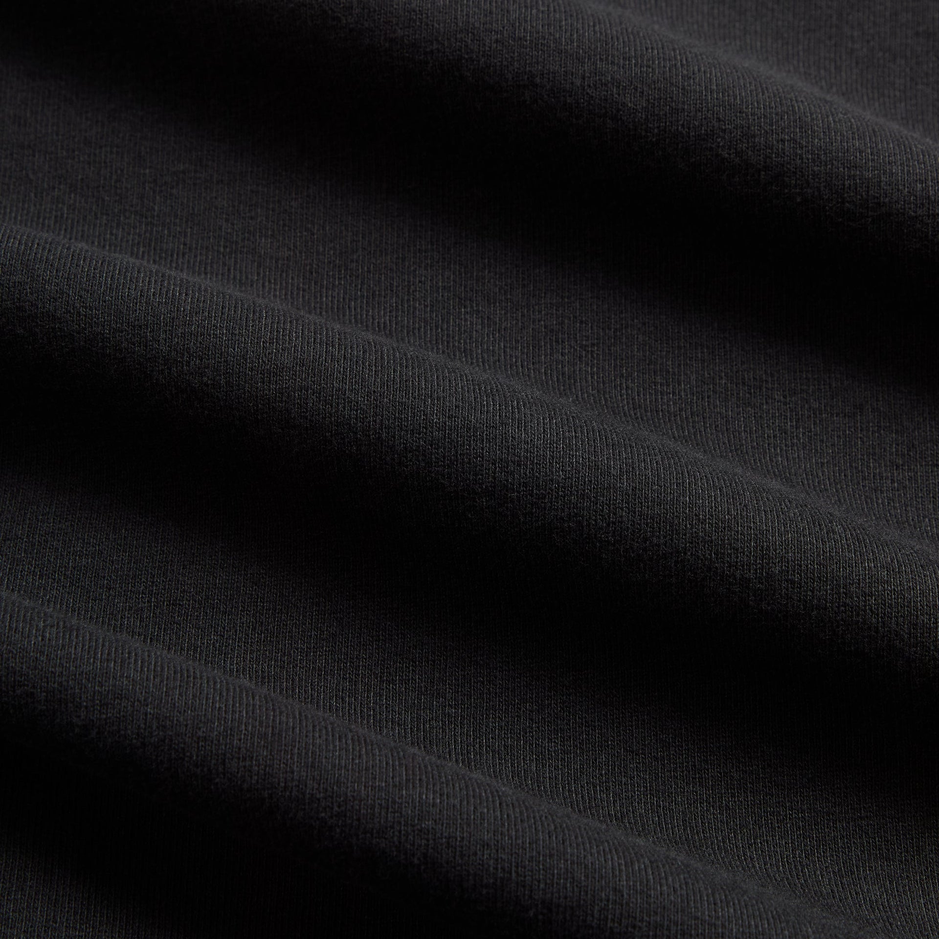 Close-up of the black fleece fabric texture on the Kith Heritage Filigree Braxton hoodie
