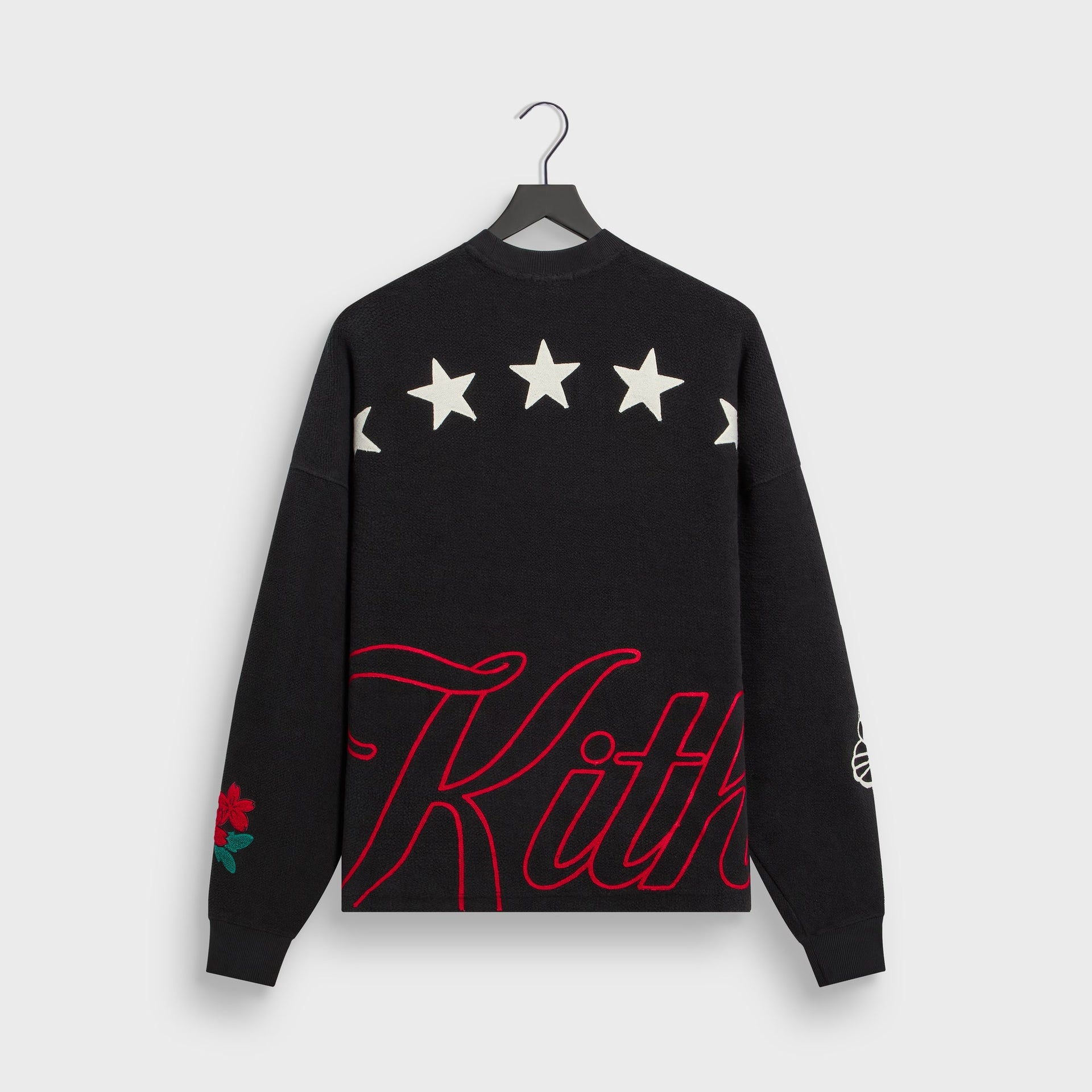 Kith Varsity Lawson crewneck in black, back flat lay with star graphics and red Kith script