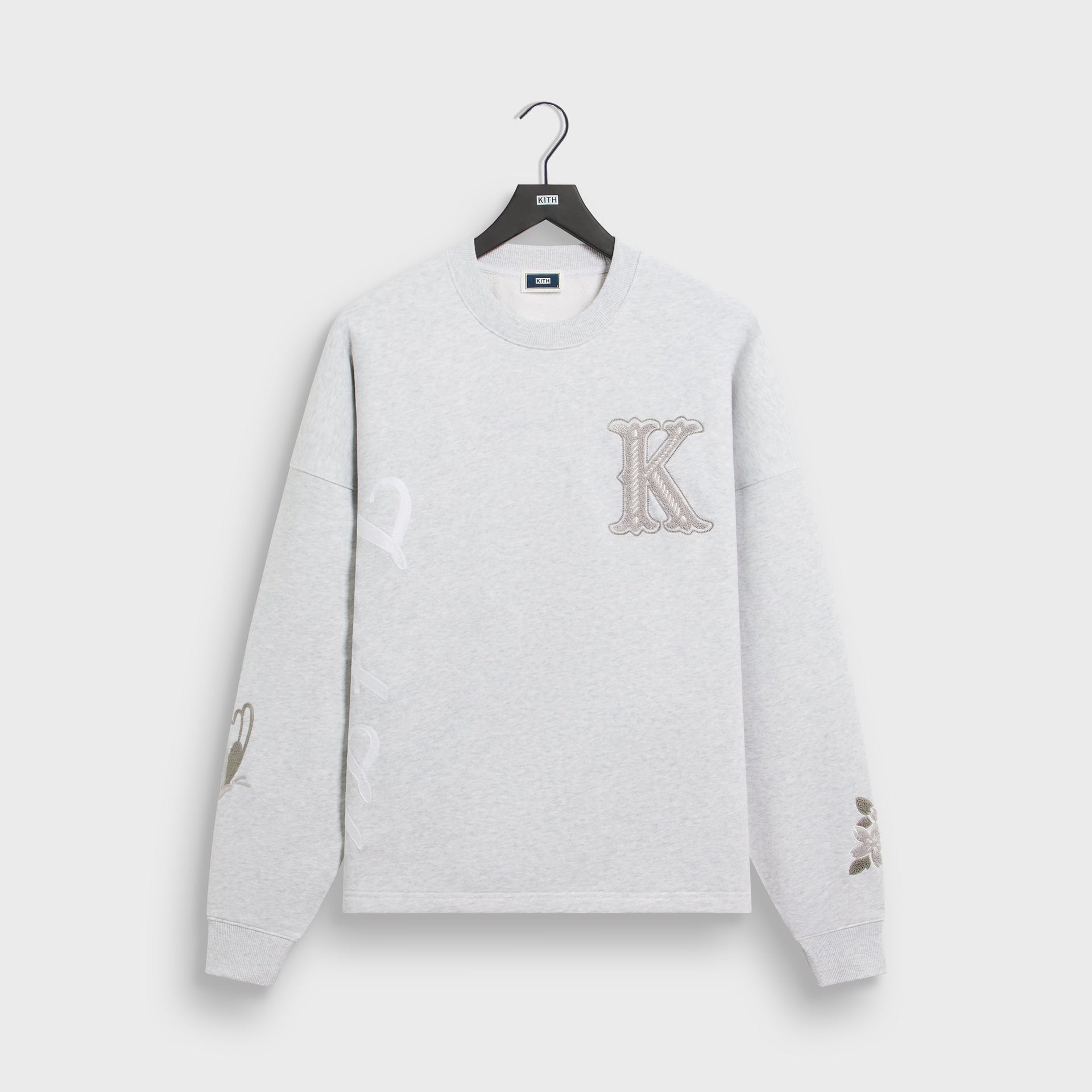 Kith Varsity Lawson crewneck in light heather grey with chenille K patch, front flat lay