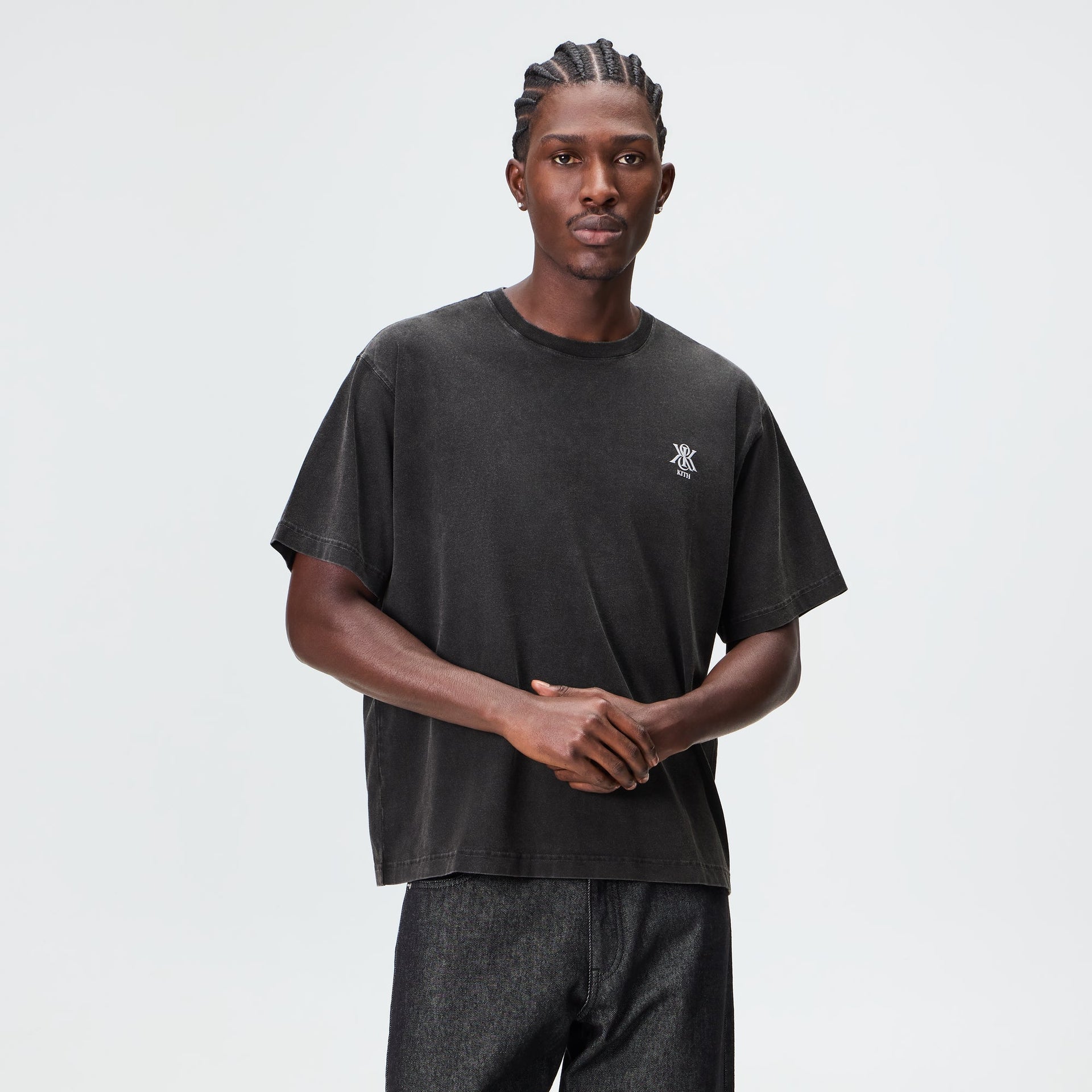Man wearing the Kith Guardian Alex boxy vintage tee in faded black, front view