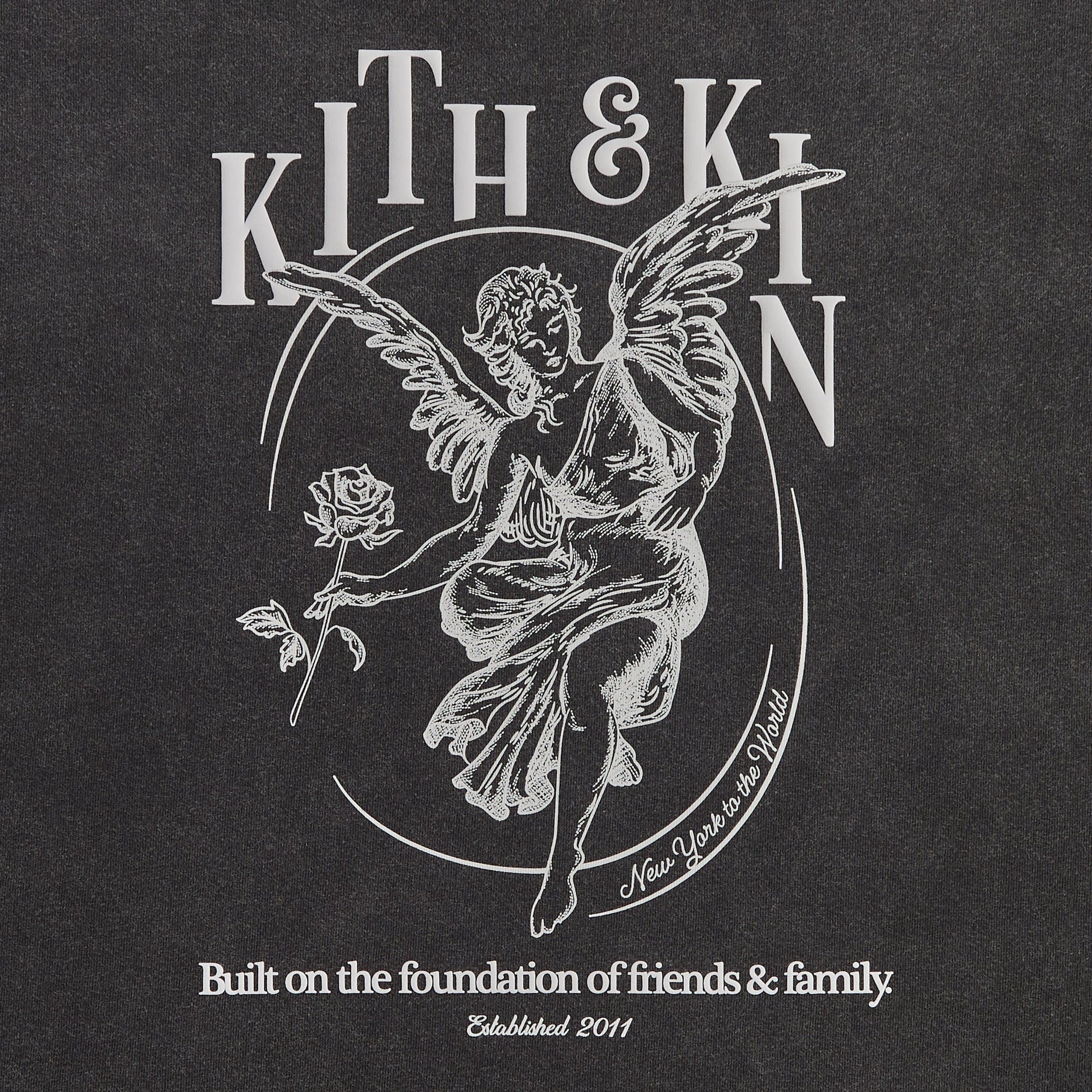 Close-up of the Kith & Kin angel graphic print reading Built on the foundation of friends and family