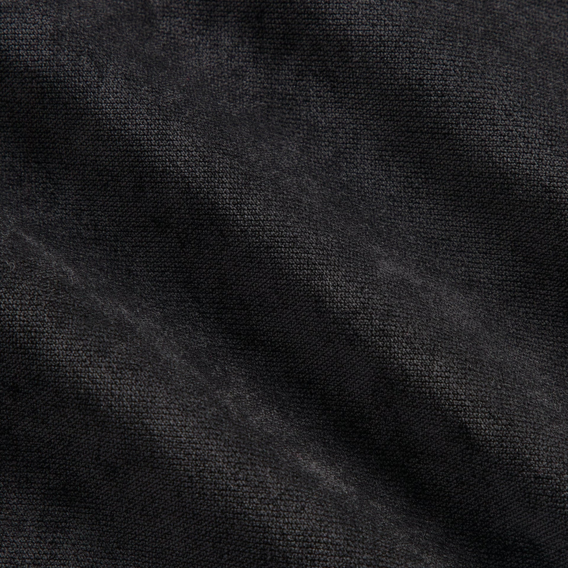 Close-up of the black jersey fabric texture on the Kith NFL Ravens Leon shirt