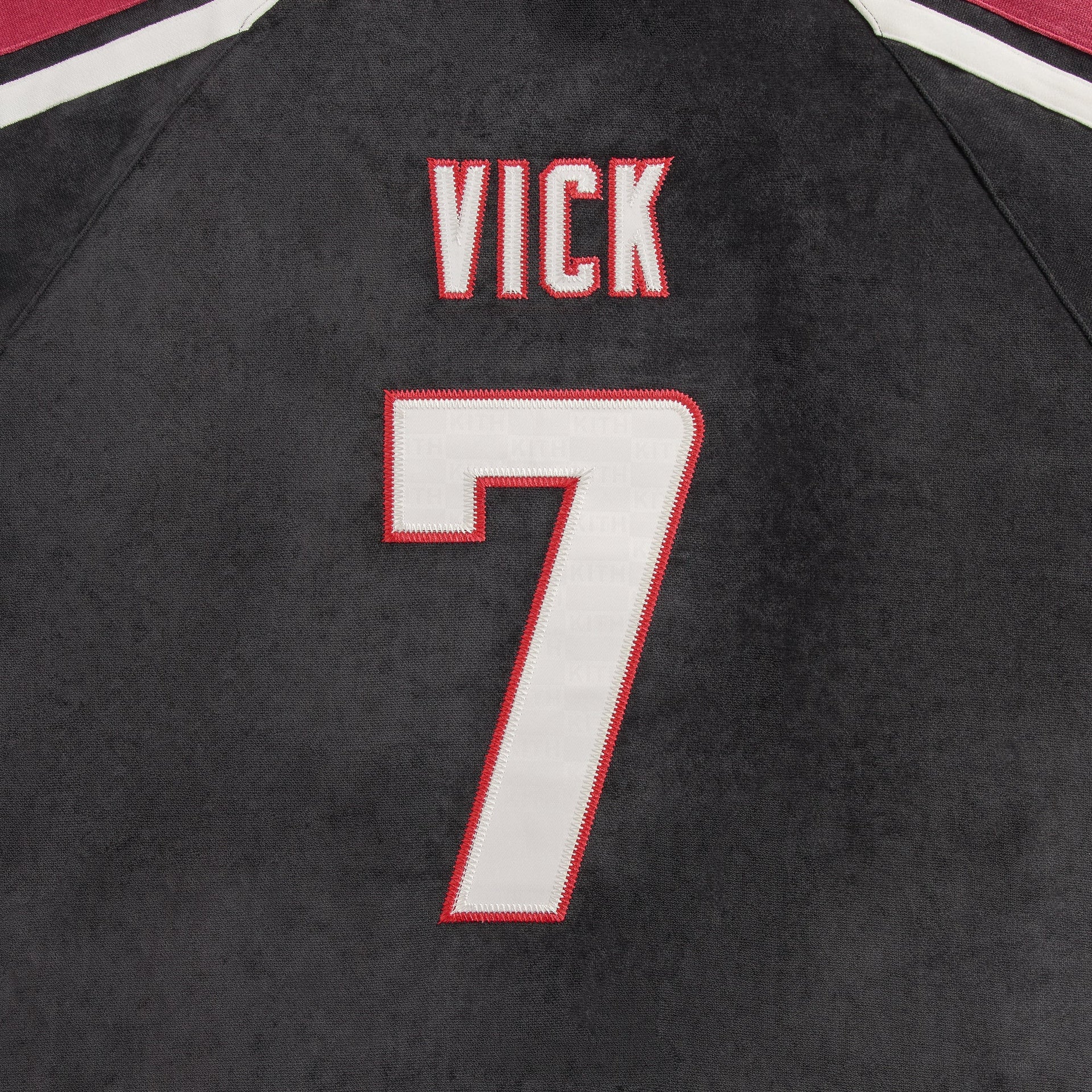 Close-up of the Vick 7 name and number on the back of the Kith NFL Falcons Leon shirt