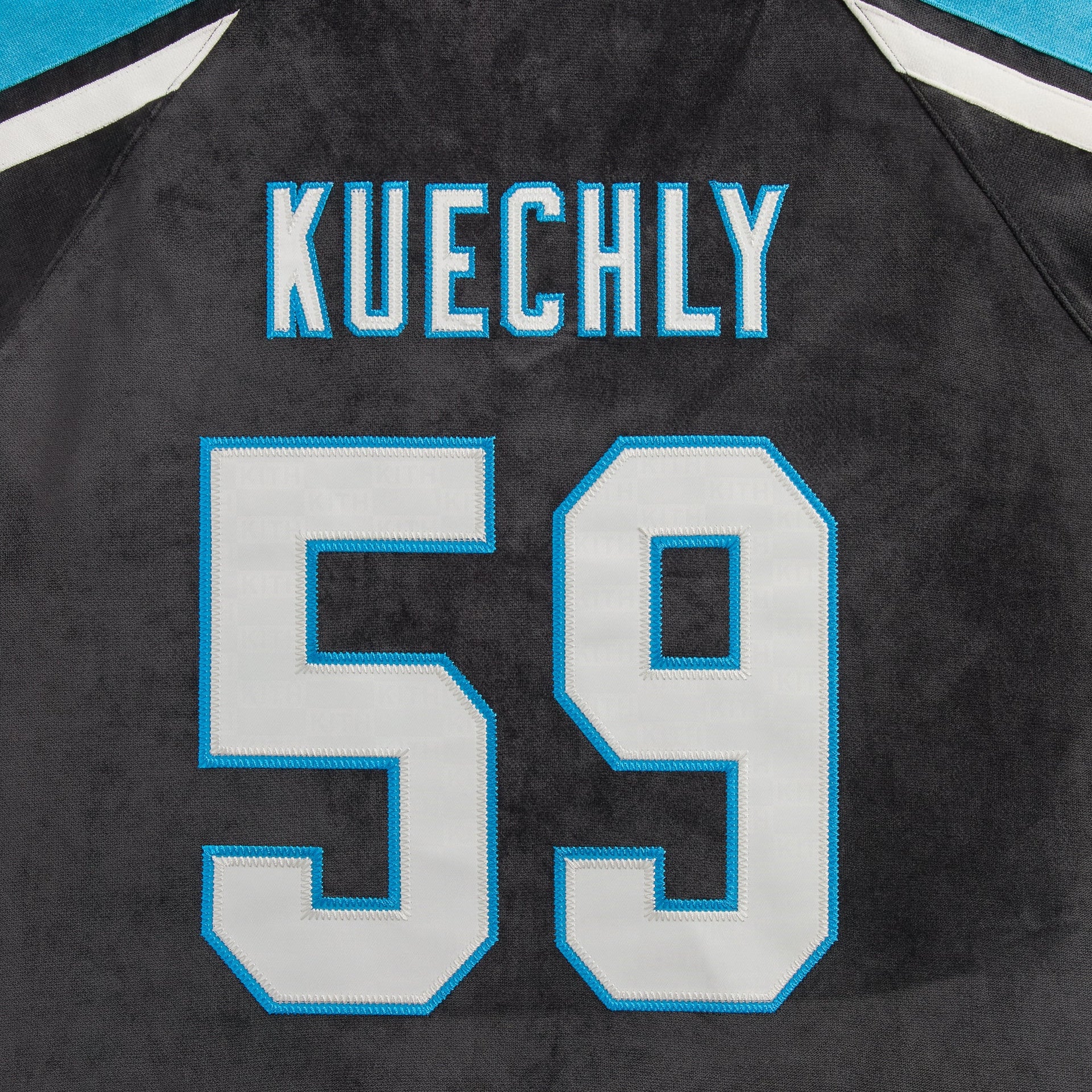 Close-up of the Kuechly 59 name and number on the back of the Kith NFL Panthers Leon shirt