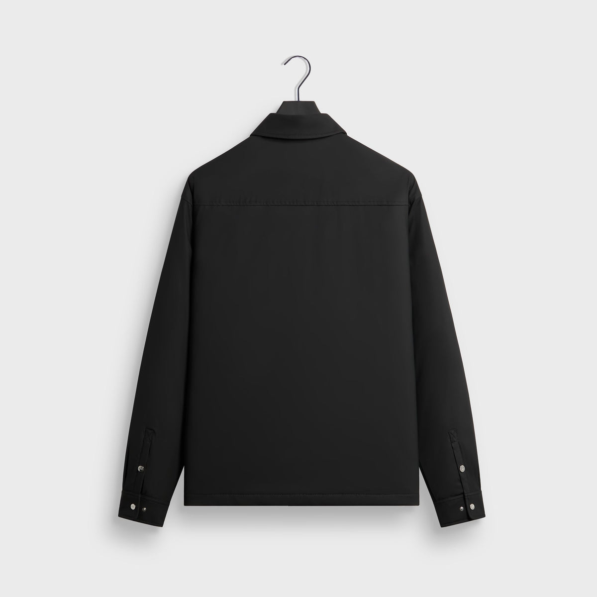 Kith Stretch Poly Brixton Shirt Jacket in black, back view on hanger with yoke seam and snap cuffs