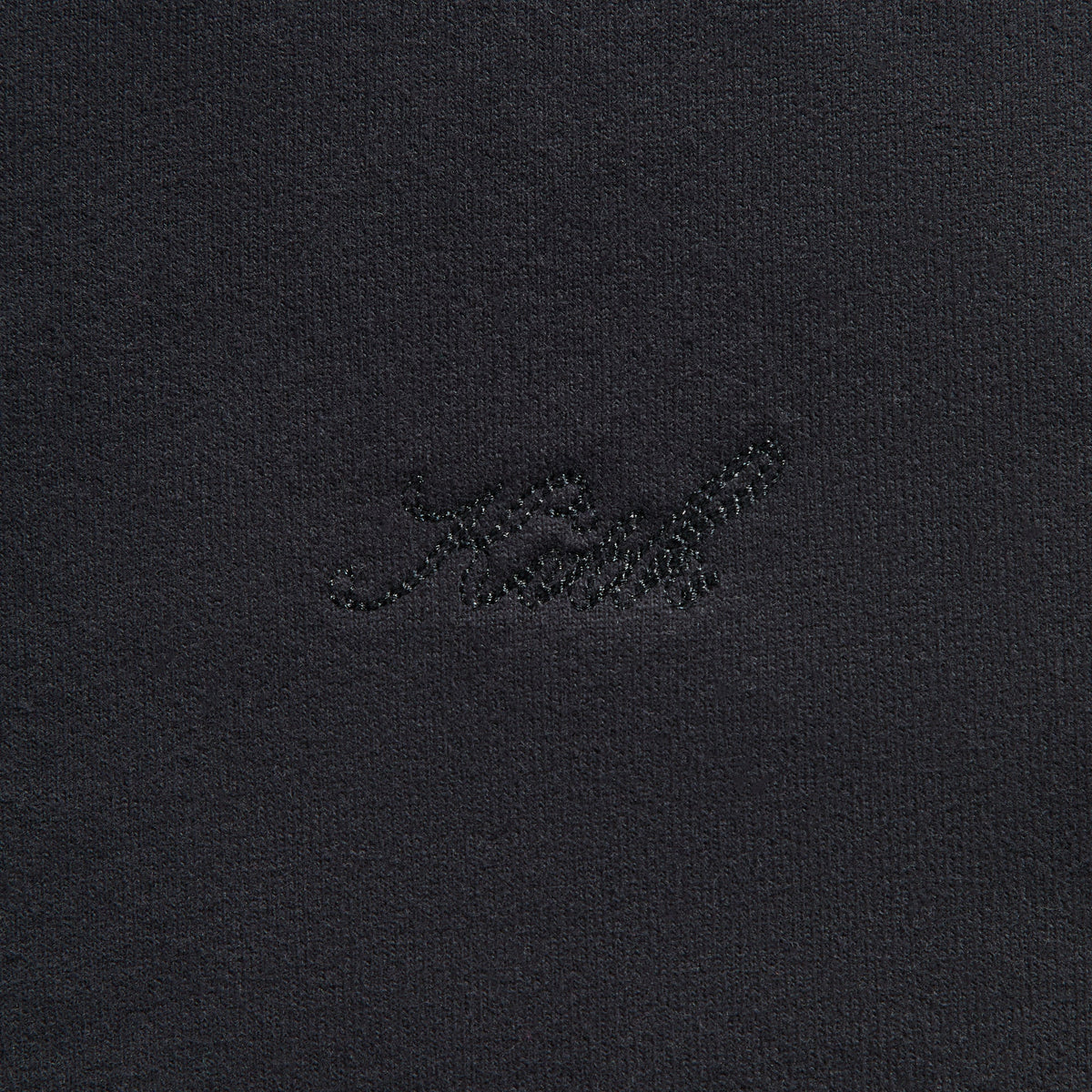 Kith Sueded French Terry Nelson Rugby Pullover in Black, close-up of tonal black embroidered Kith script logo on chest