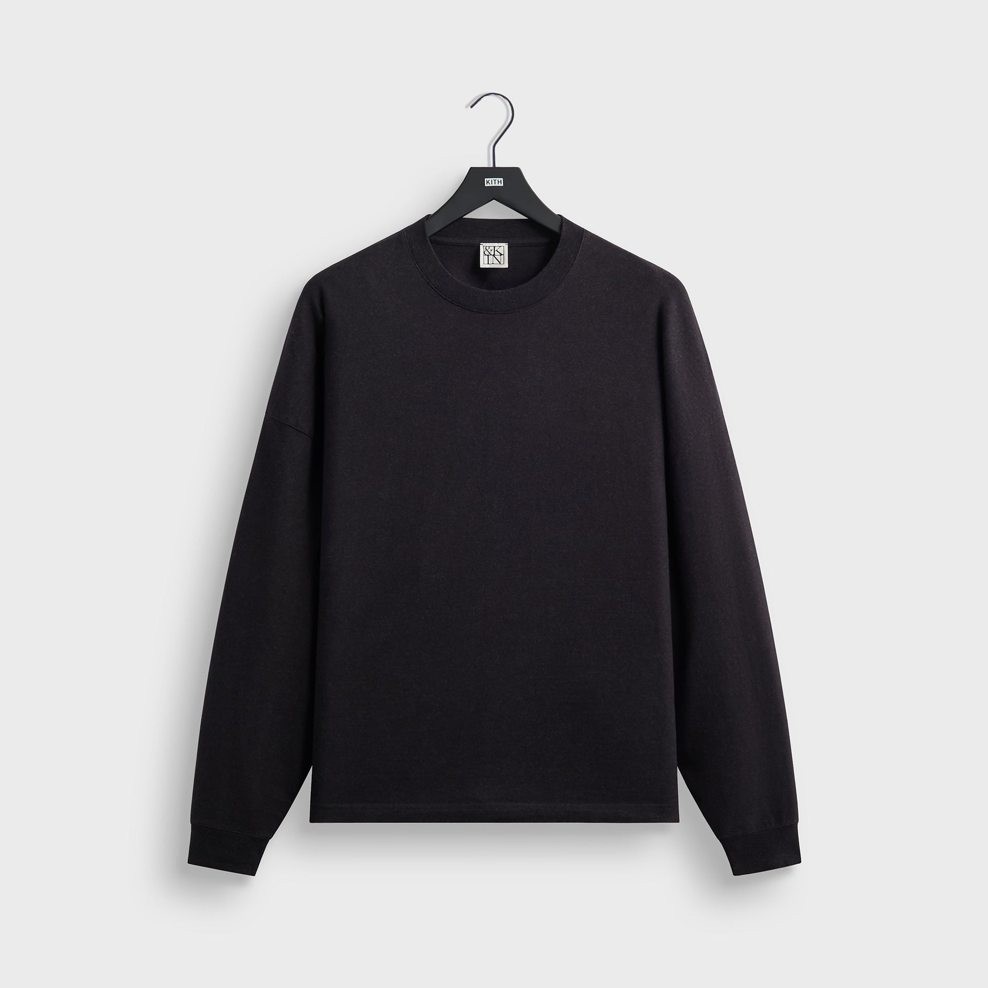 &Kin Long Sleeve Lawson Tee in black, front view on KITH hanger, crewneck with ribbed cuffs