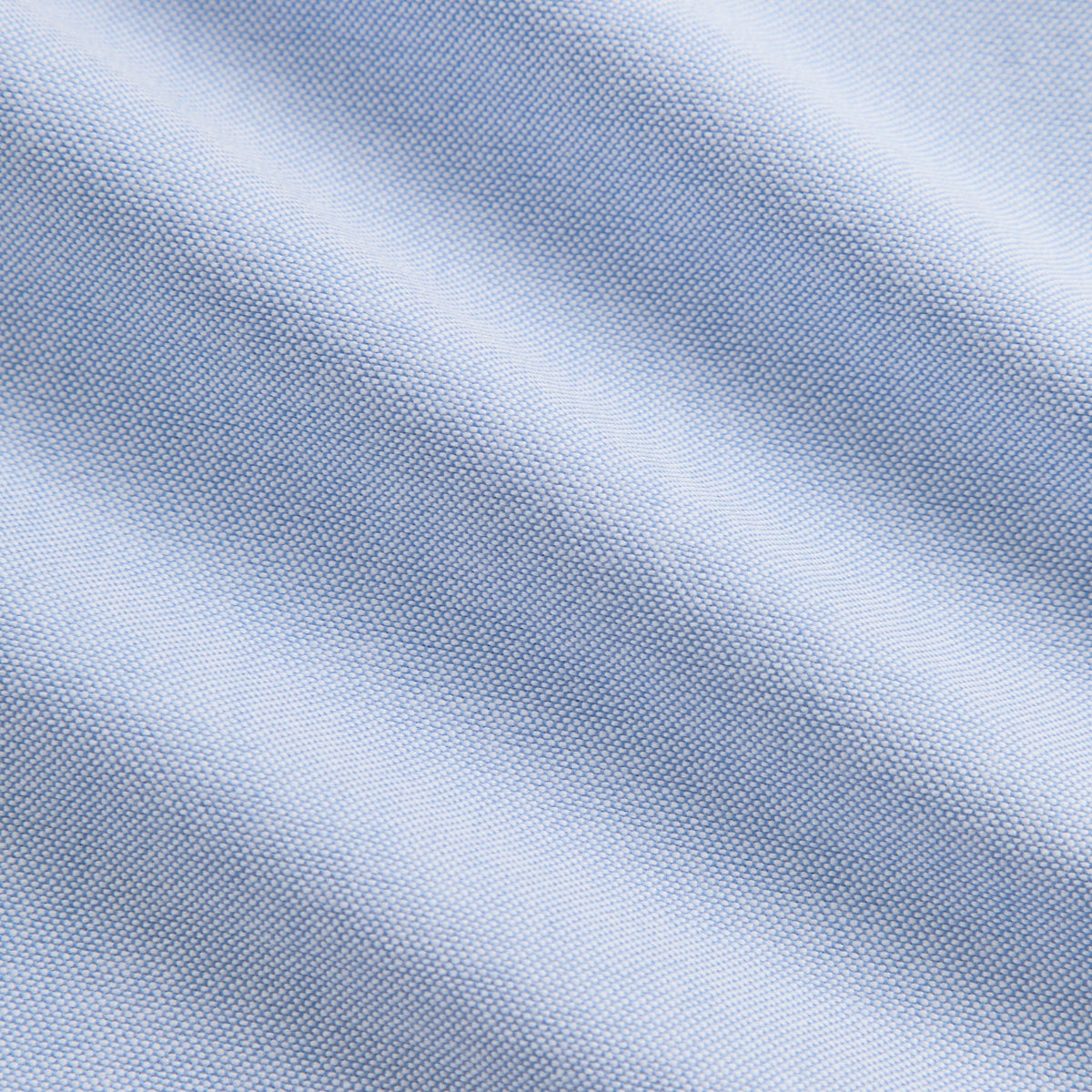 Close-up of light blue Oxford weave fabric texture on the Deon overshirt