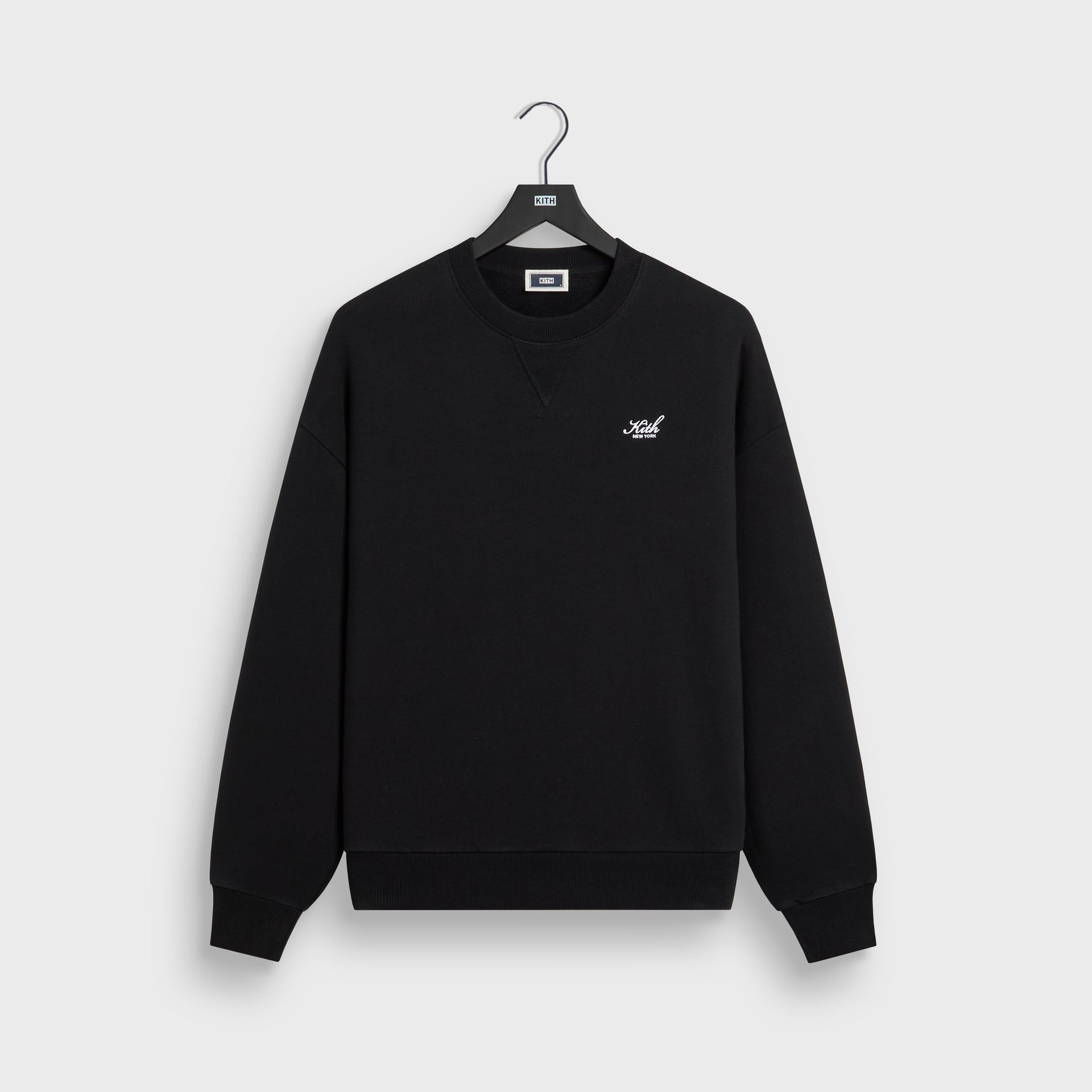 Kith Nelson crewneck in black cotton fleece, front flat lay on hanger