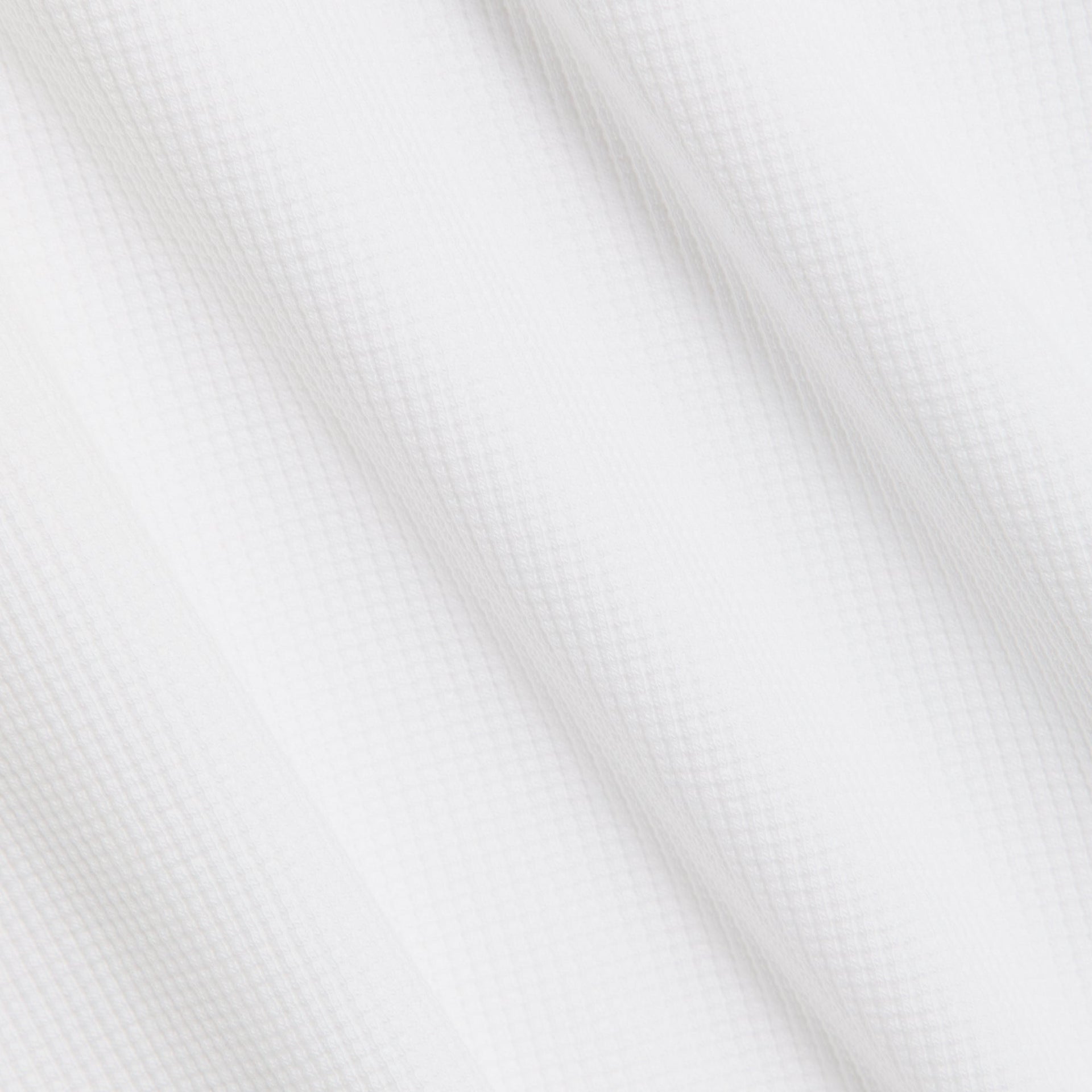 Close-up of the micro waffle knit texture on the Kith Colby pullover in white