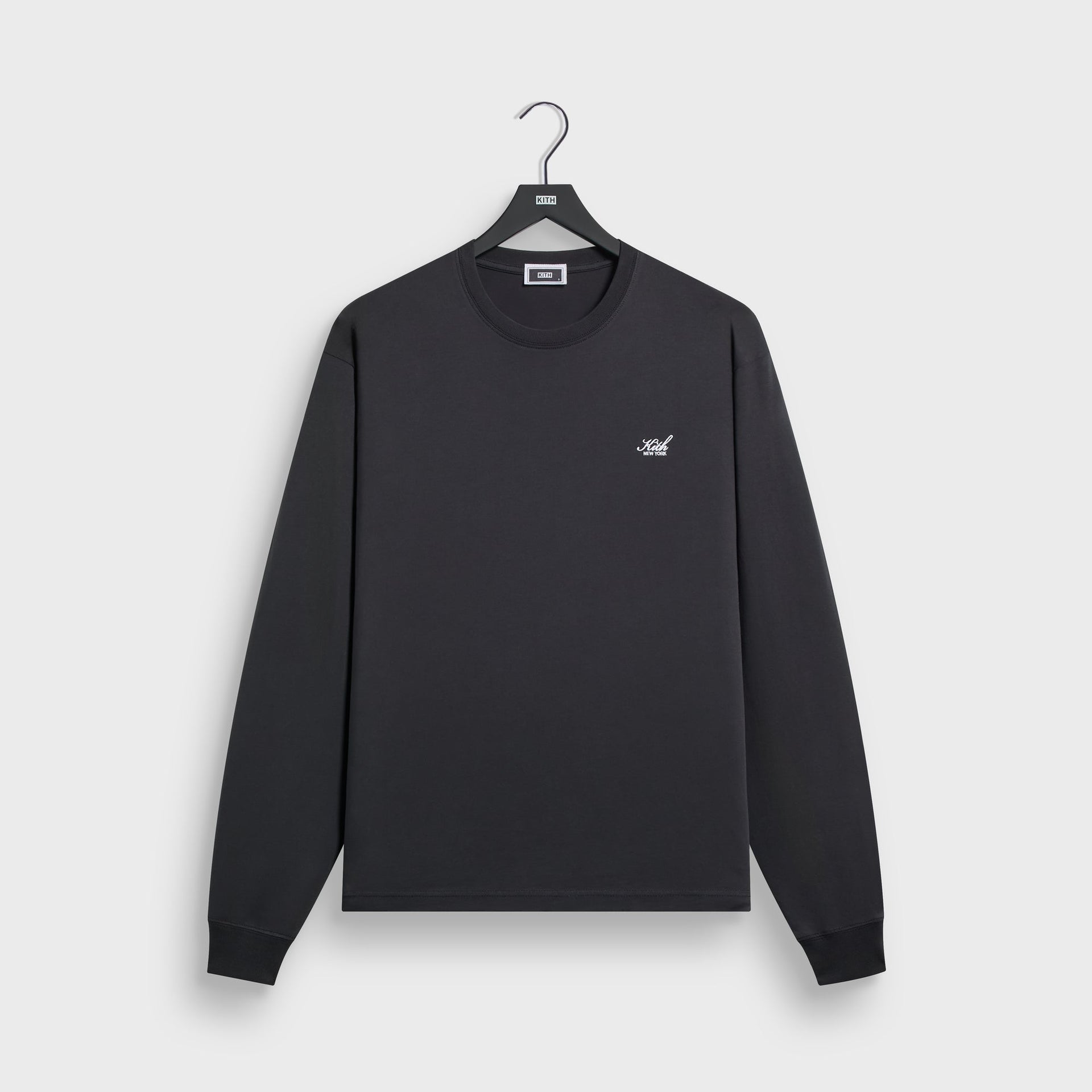Kith Long Sleeve LAX tee in black cotton with small crest chest logo, front flat lay on hanger
