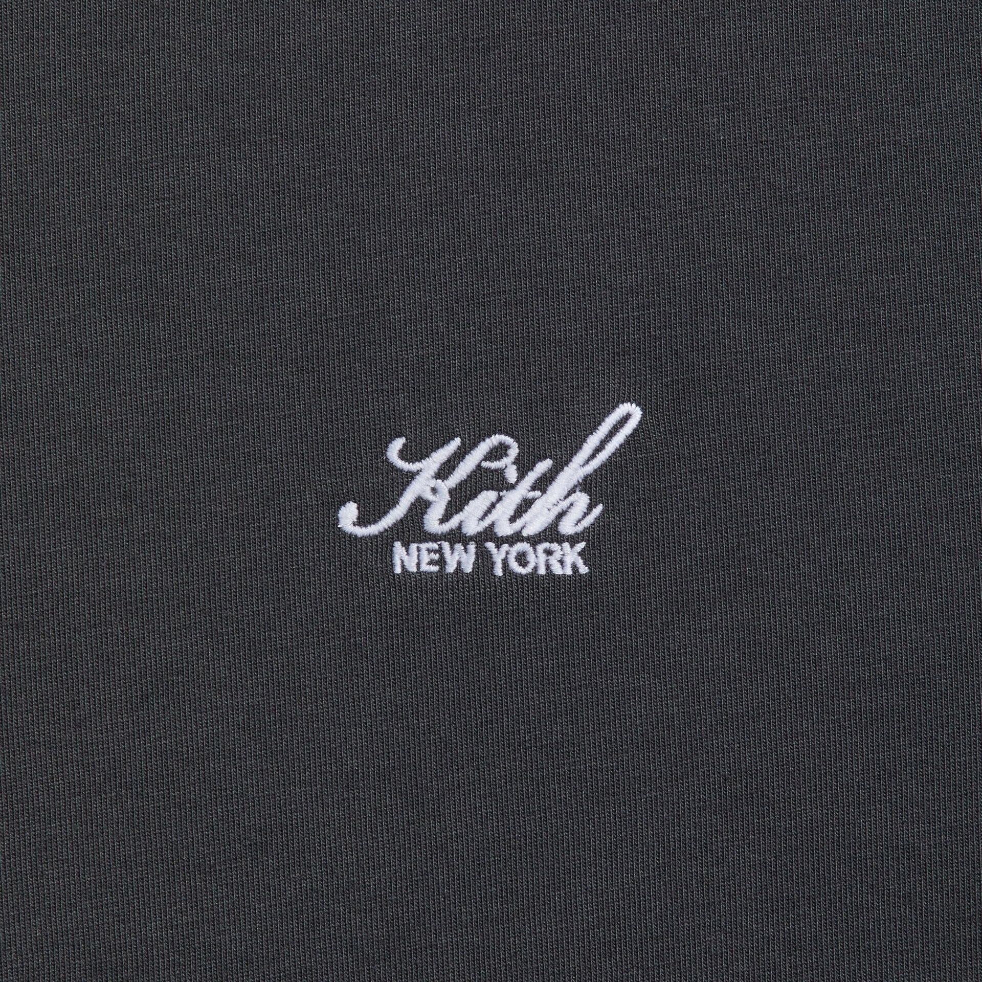 Close-up of the embroidered Kith New York script logo on the Long Sleeve LAX tee in black