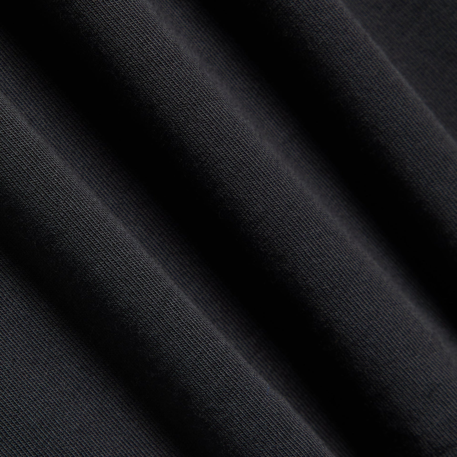 Close-up of the black cotton fabric texture on the Kith Long Sleeve LAX tee