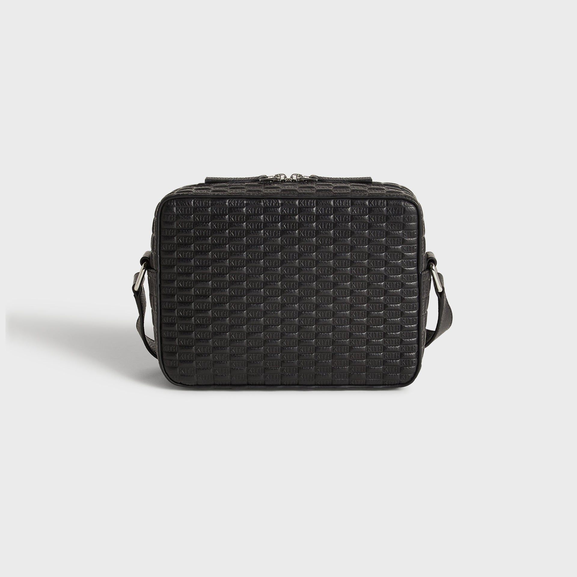 Kith Monogram Tumbled Leather Camera Crossbody Bag in Black, back view showing pebbled leather panel and strap