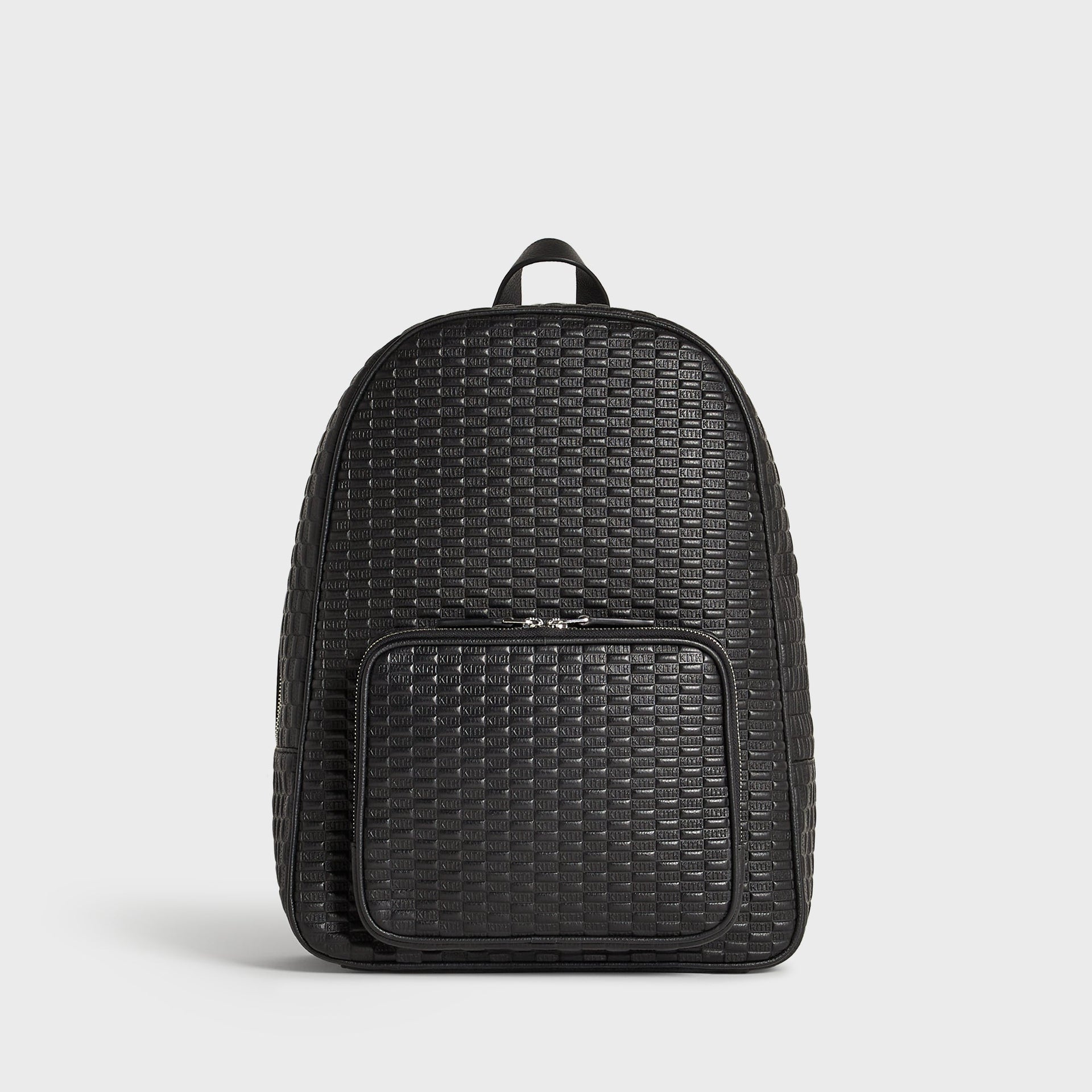 Kith Monogram Tumbled Leather Backpack in black, front view with top carry handle and zip front pocket bearing the Kith wordmark.