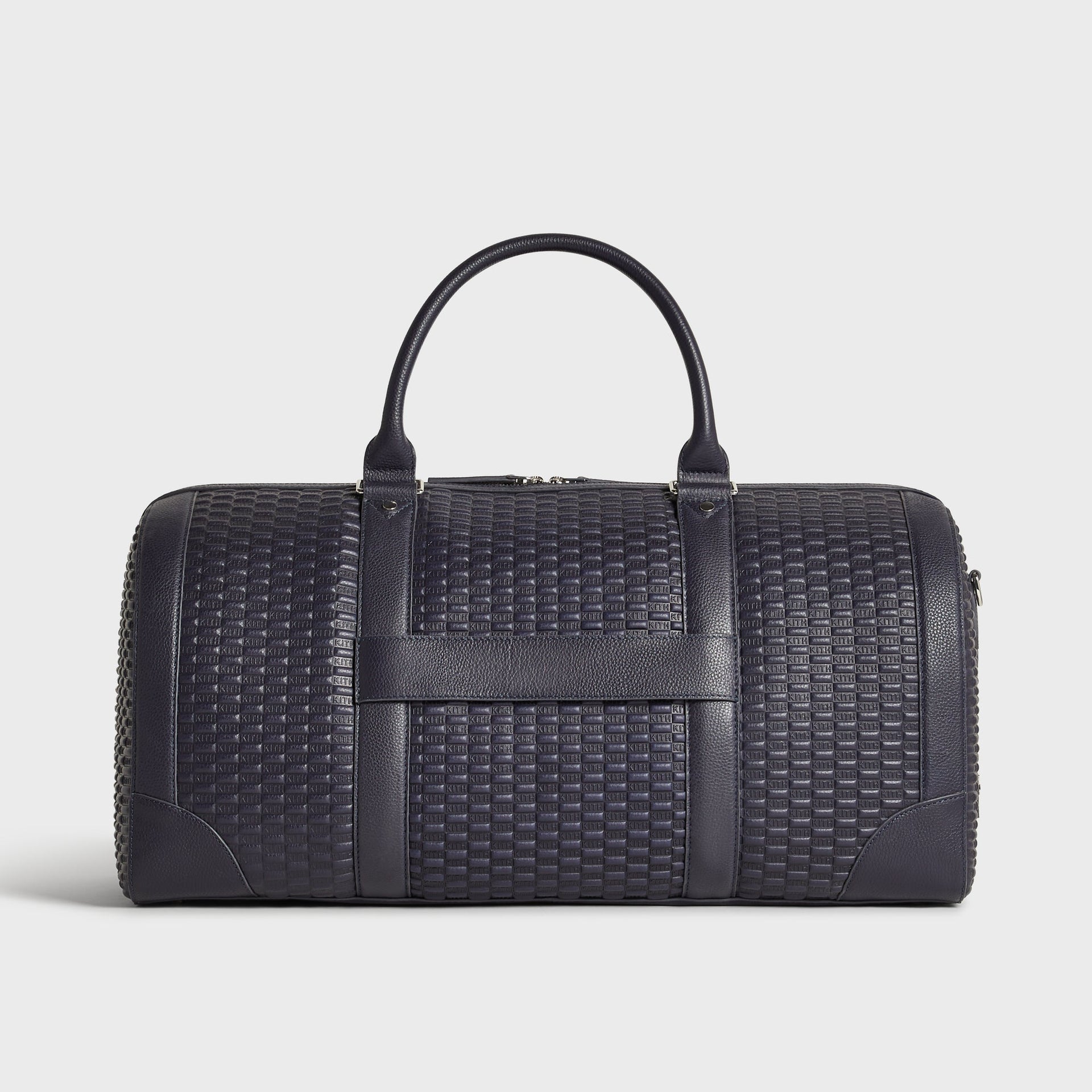 Back view of Kith Monogram Traveler K55 Duffle Bag in Ink showing embossed KITH leather pattern