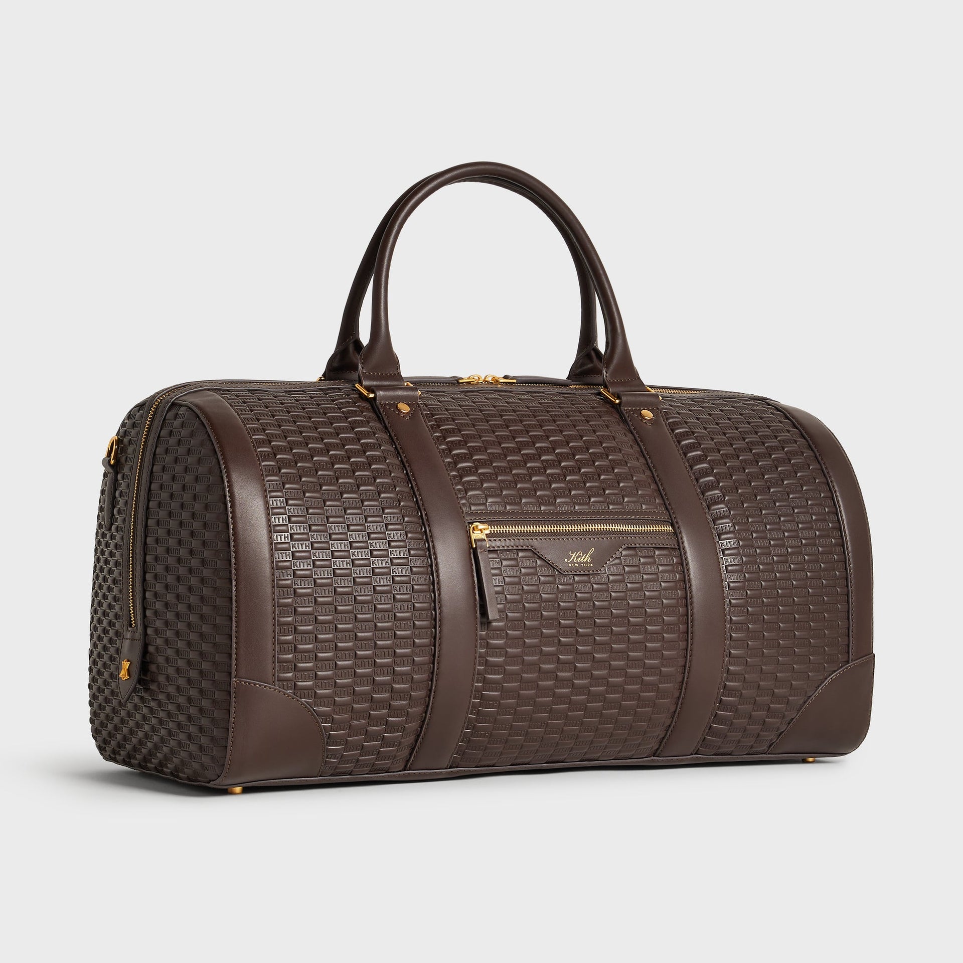 Three-quarter angle view of the Kith Traveler K55 Duffle Bag in Zoom brown embossed leather