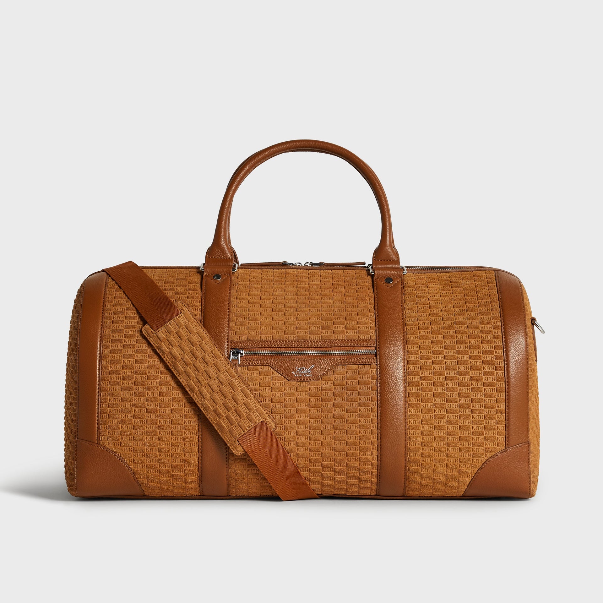 Kith Monogram Suede Traveler K55 Duffle Bag in Argil tan, front view with leather trim and detachable strap