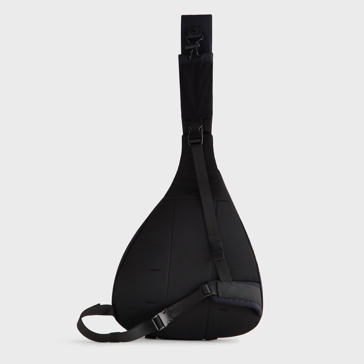 Kith Nylon Ripstop Sling Backpack in navy black, front strap view with crossbody buckle