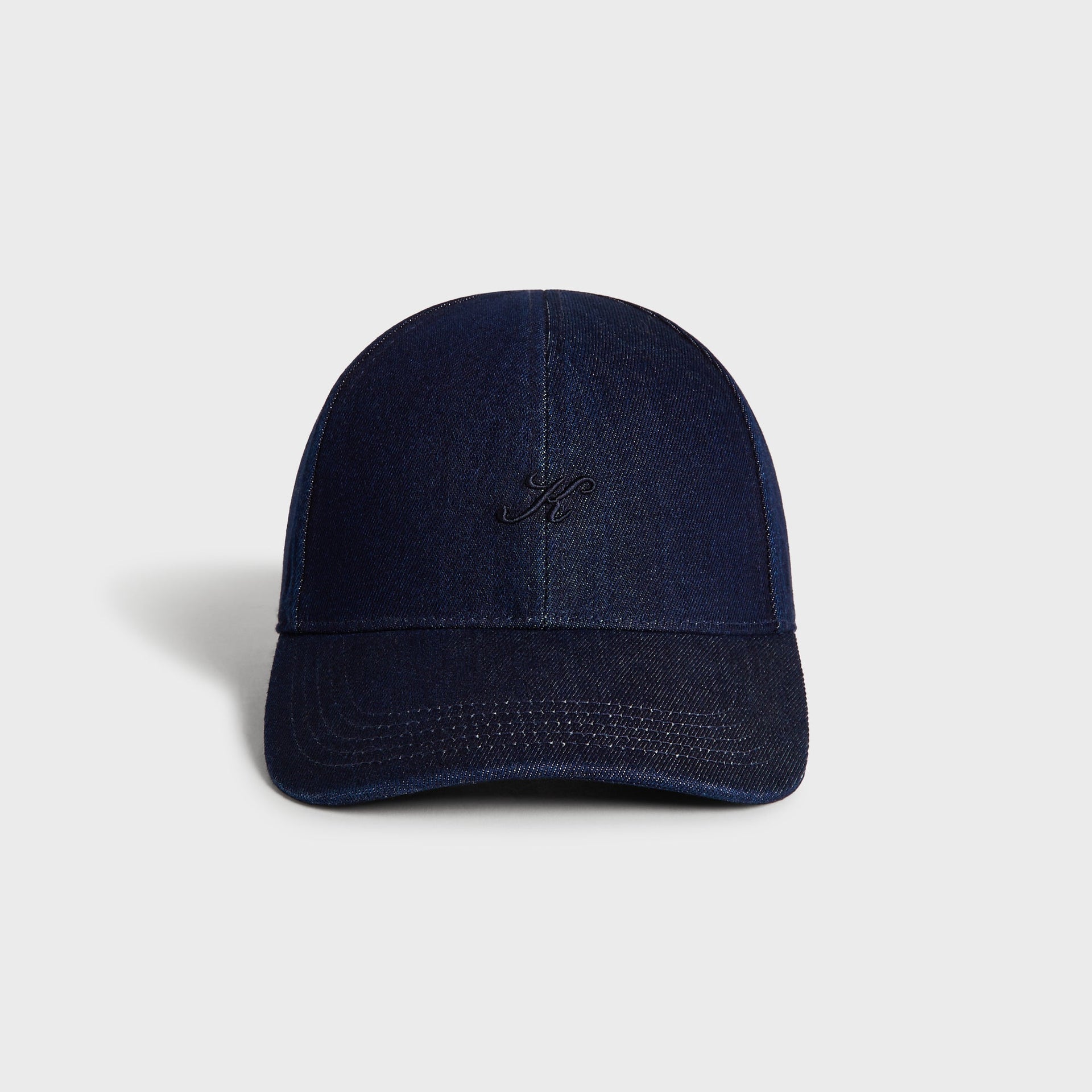Kith Low Profile Raw Denim Classic Cap in Savin Wash, front view showing dark indigo denim and embroidered K logo on the crown