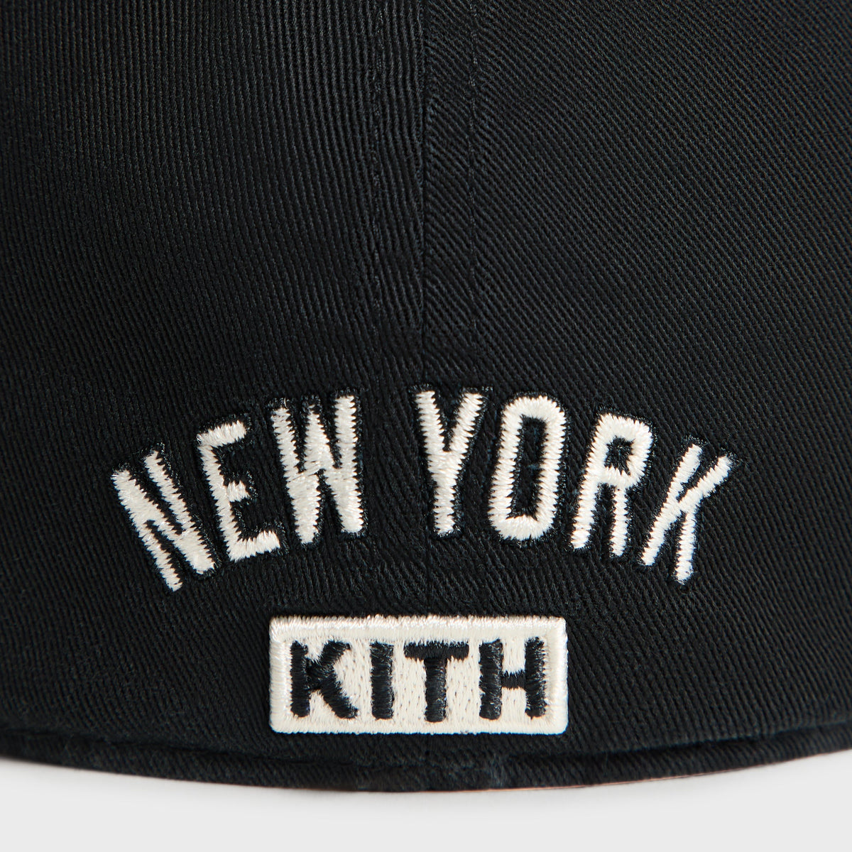 Close-up of New York arched text and Kith wordmark patch on back of Kith & '47 Yankees cap in black
