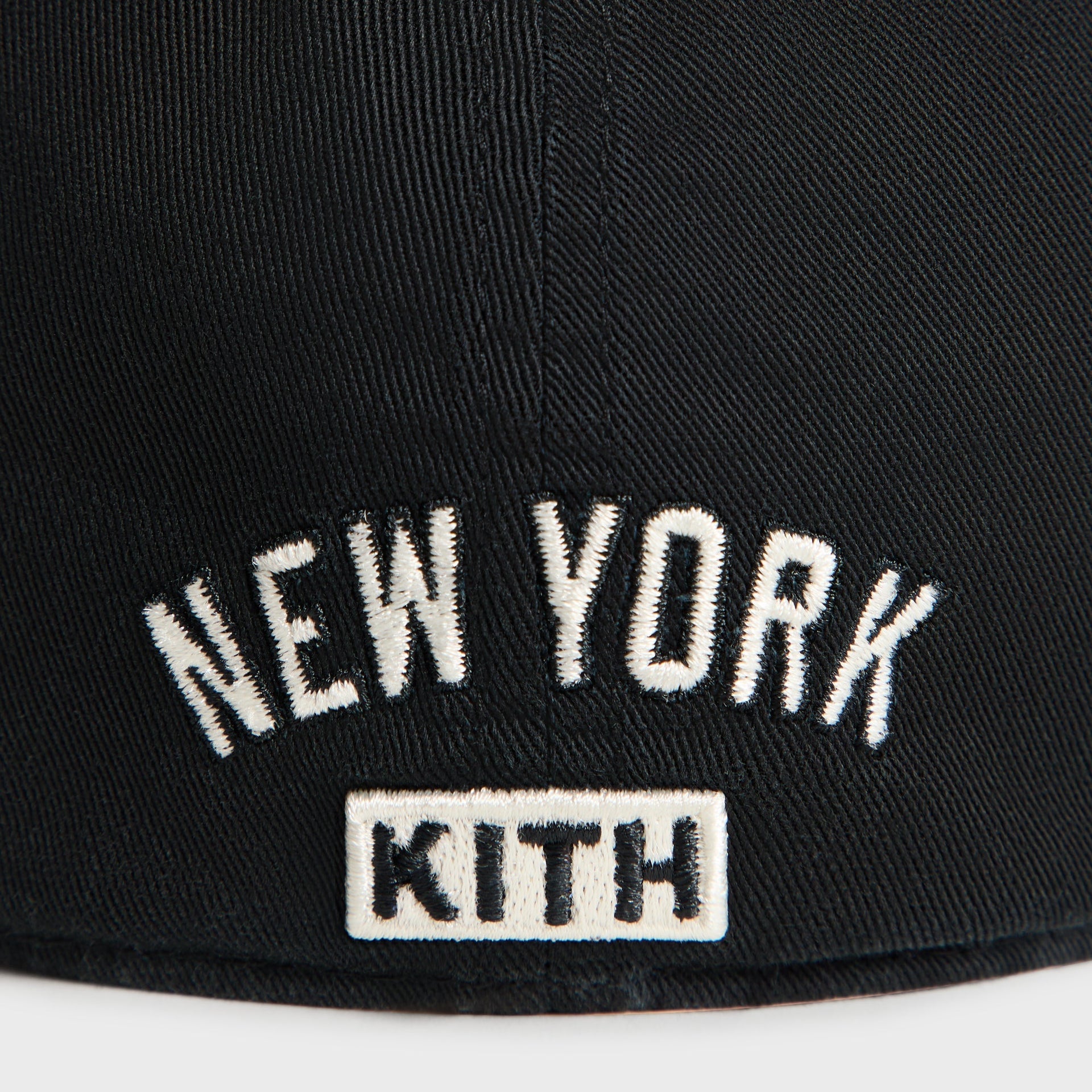 Close-up back detail of New York Kith text embroidery on Black Sun Faded Franchise LS Cap