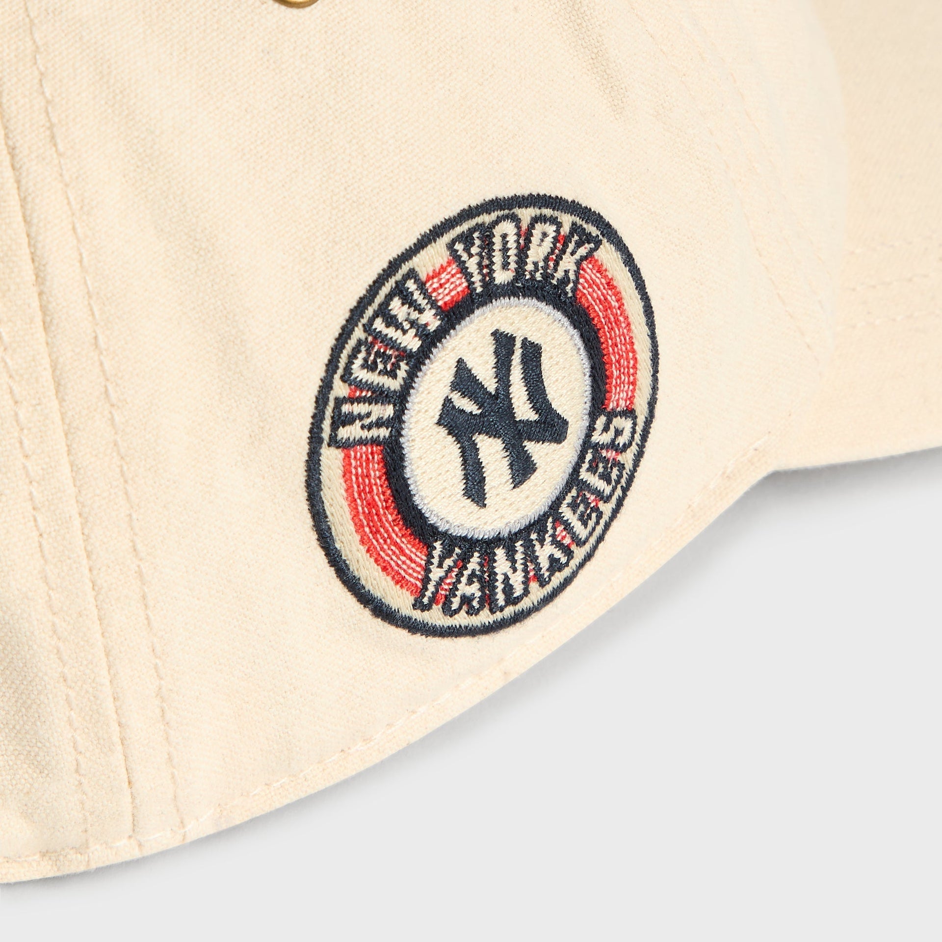 Close-up of circular New York Yankees side patch on Sandrift Duck Canvas Long Visor Cap