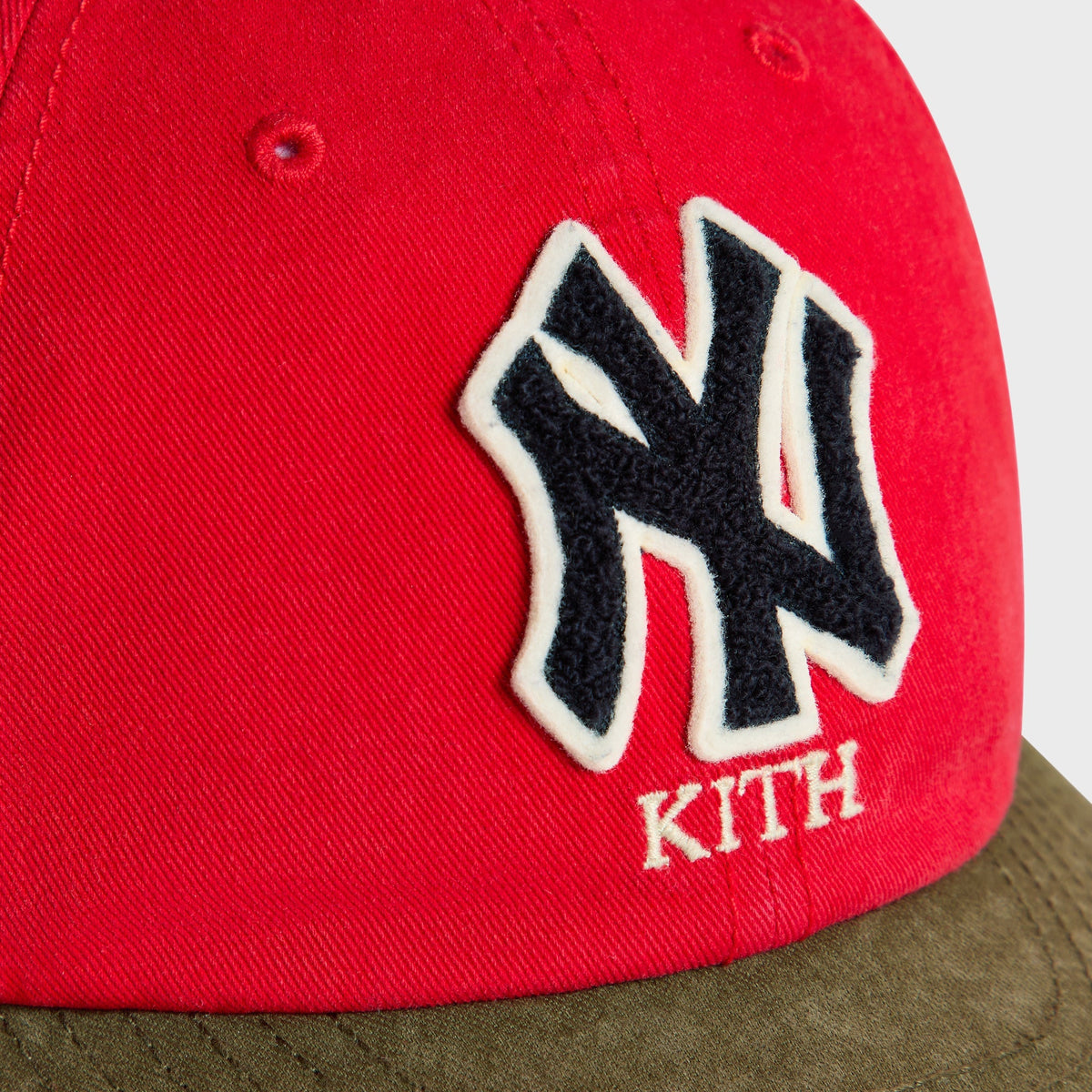 Close-up of NY chenille patch and Kith wordmark on Retro Clean Up Round Visor Cap