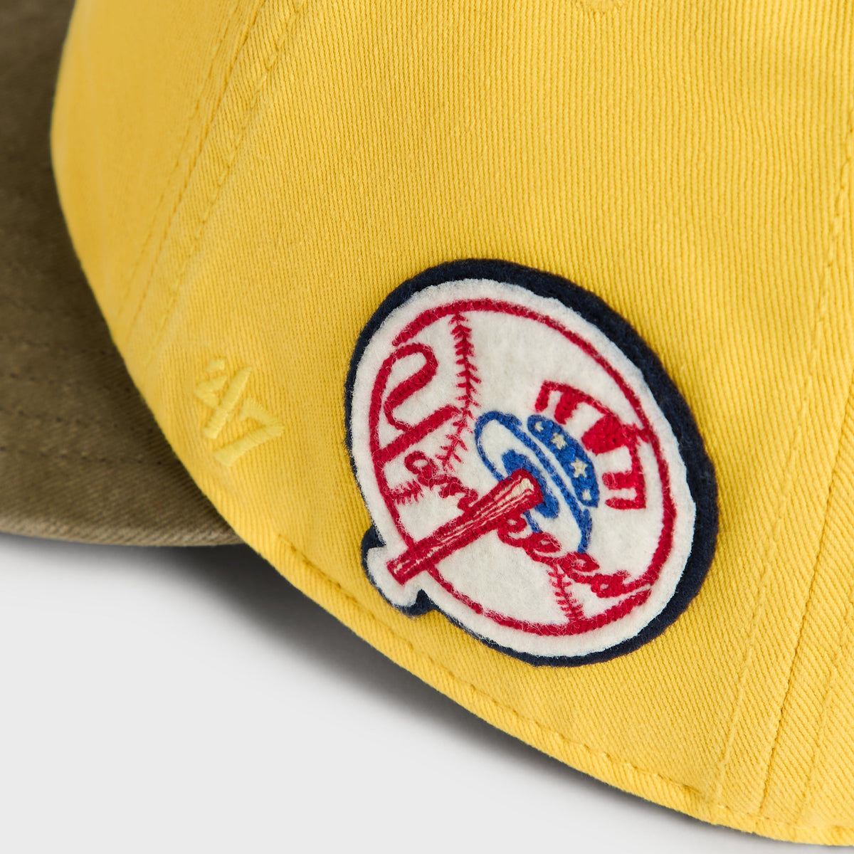 Close-up of circular vintage New York Yankees side patch on Buzz Round Visor Cap