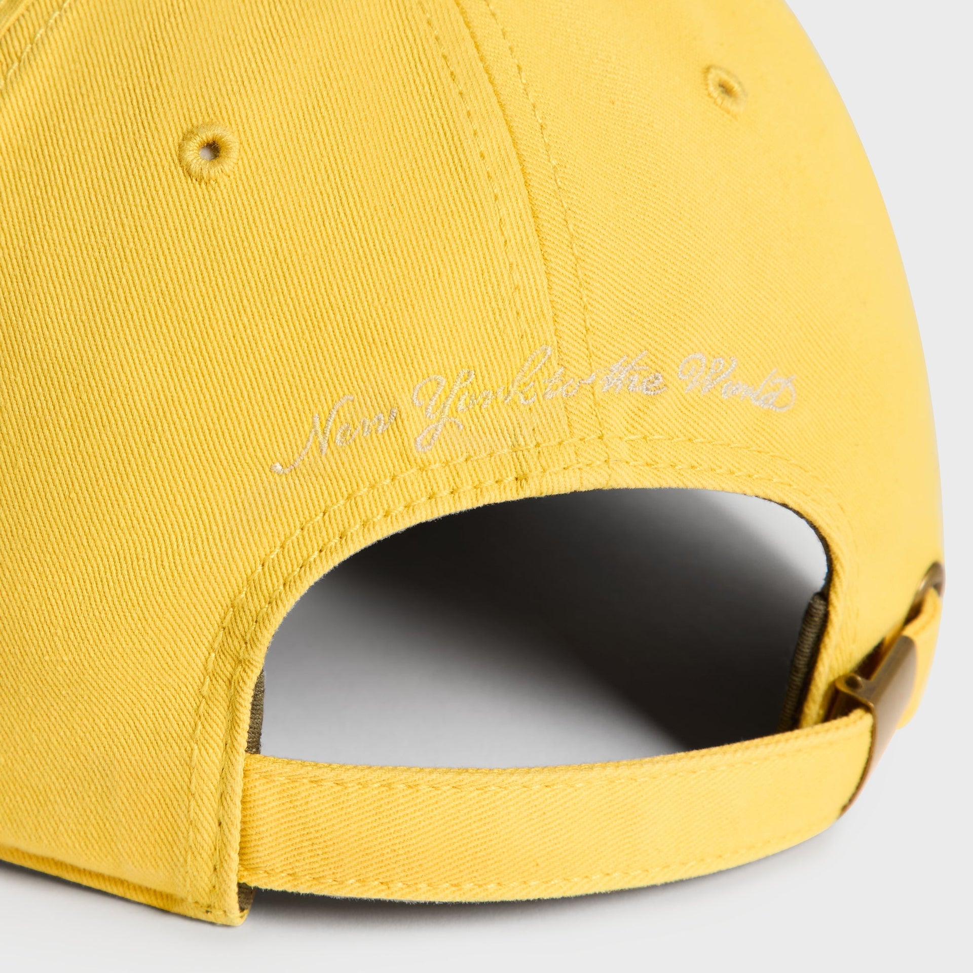 Close-up back detail of Buzz cap showing New York to the World script embroidery