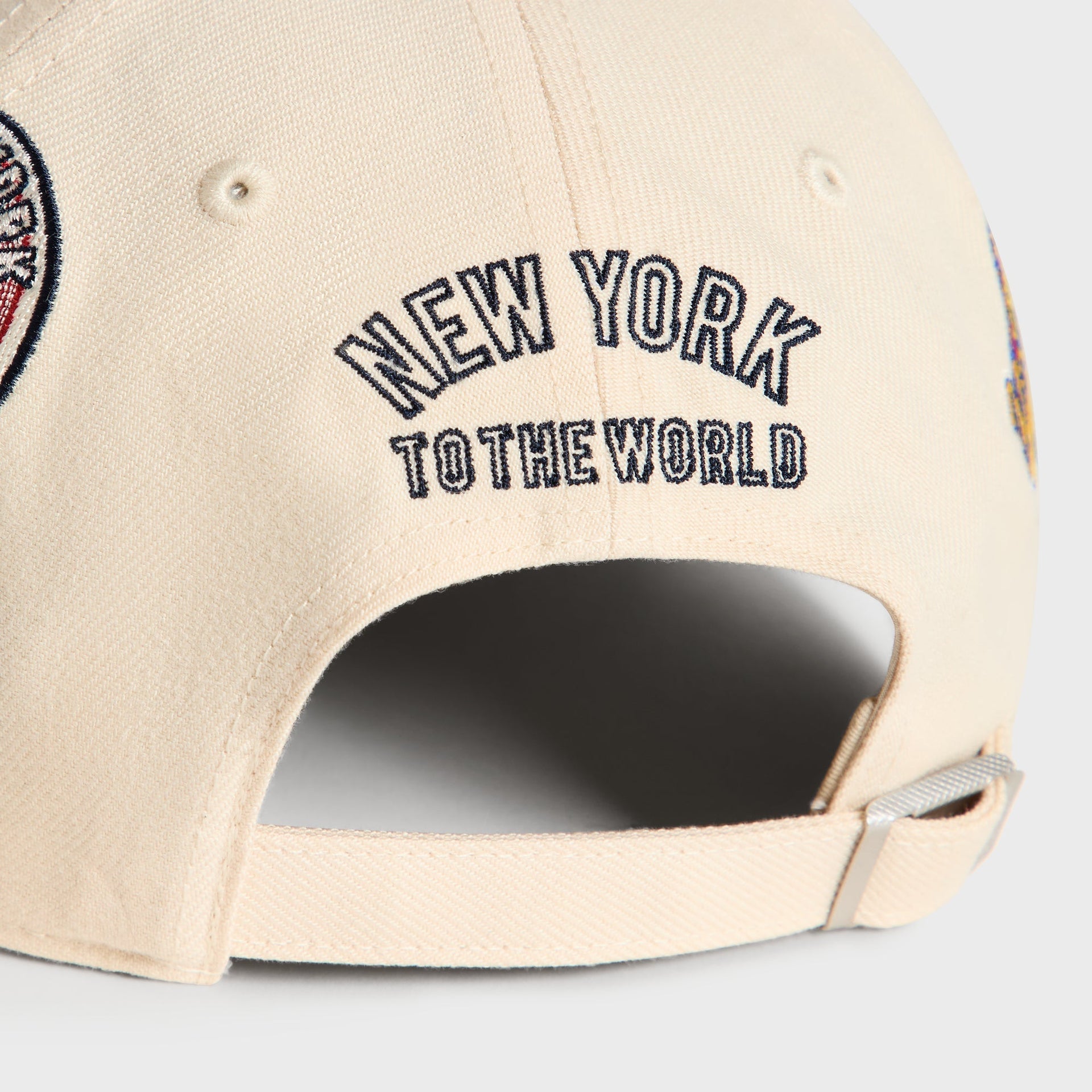 Close-up back detail of Sandrift cap showing New York To The World embroidery