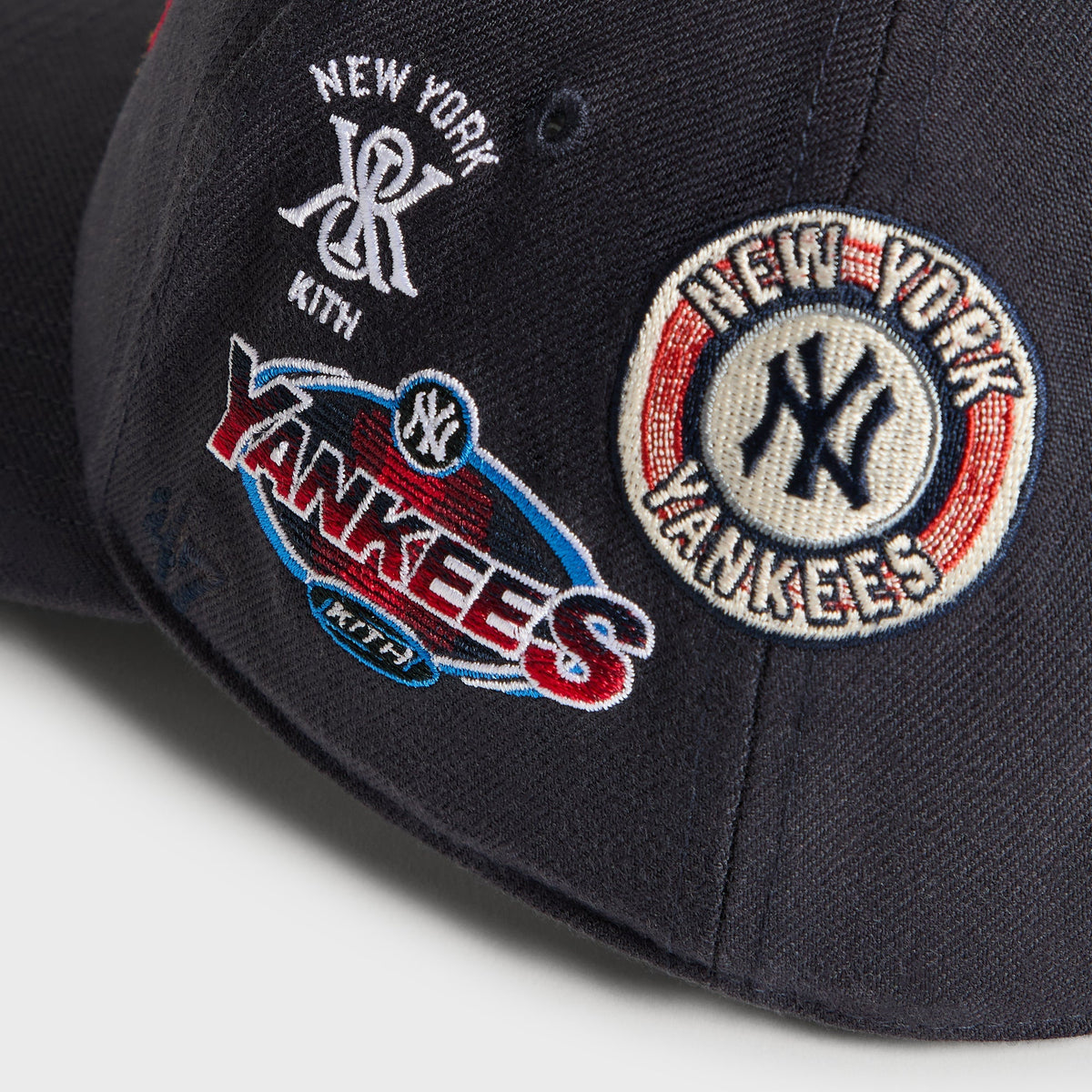 Detail of right-side patches: New York Kith monogram and Yankees zeppelin logo on Nocturnal cap
