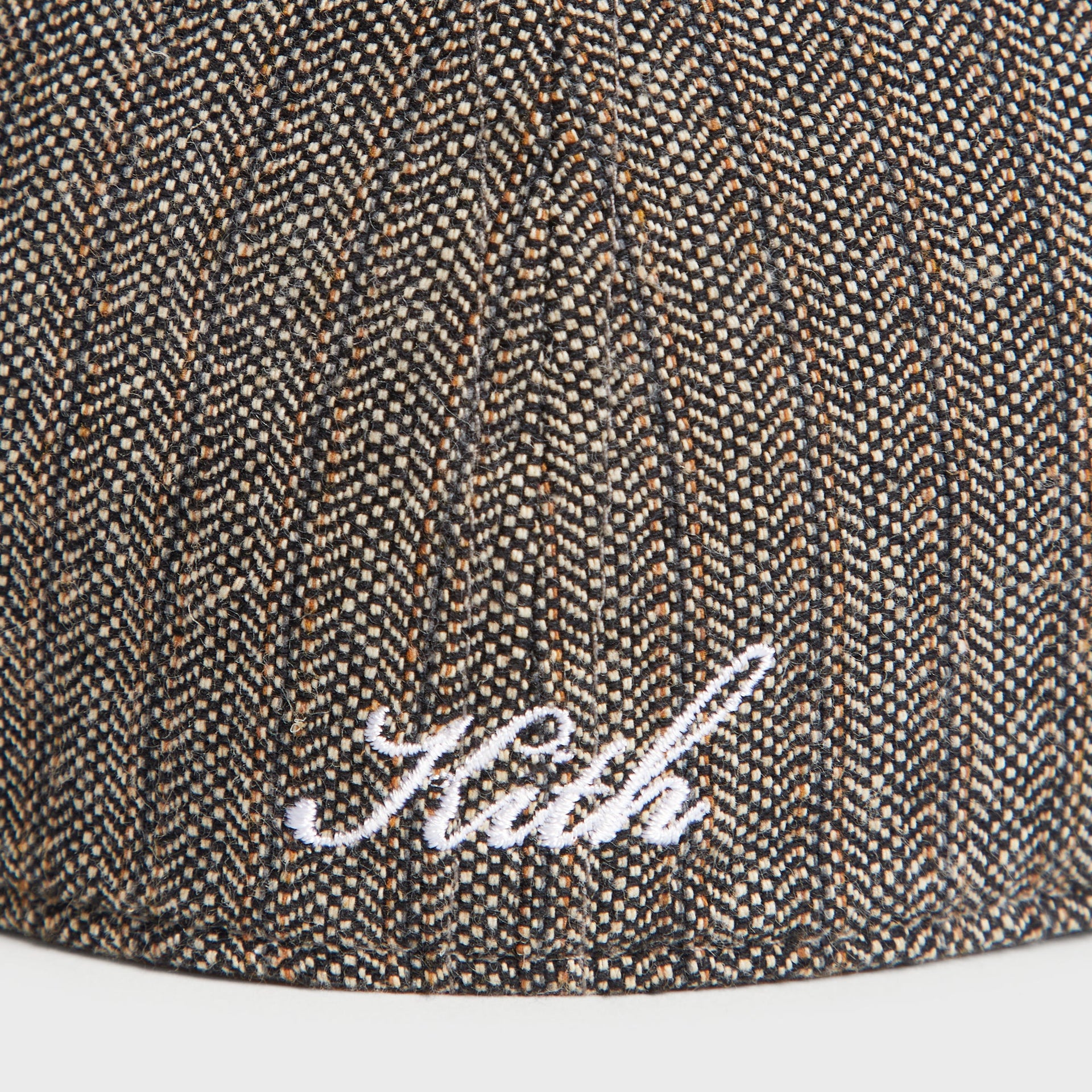 Close-up of the embroidered Kith script on the striped herringbone fabric of the Apocalypse Franchise LS Cap