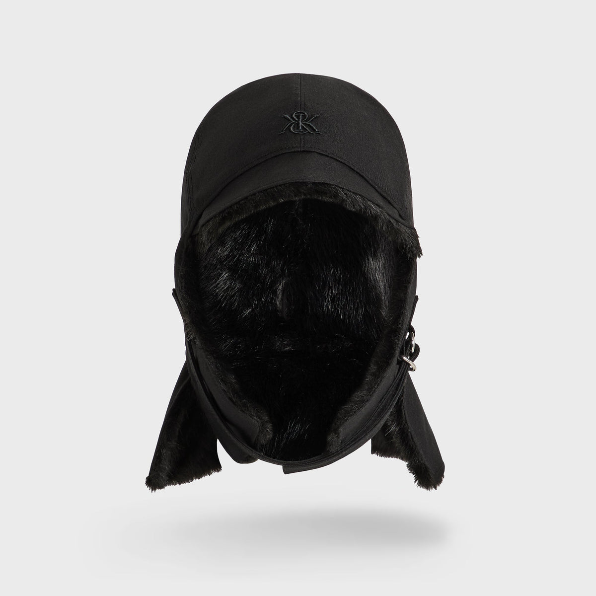 Kith Shearling Lined Waxed Canvas Trapper Hat in black, front view with faux shearling lining and earflaps