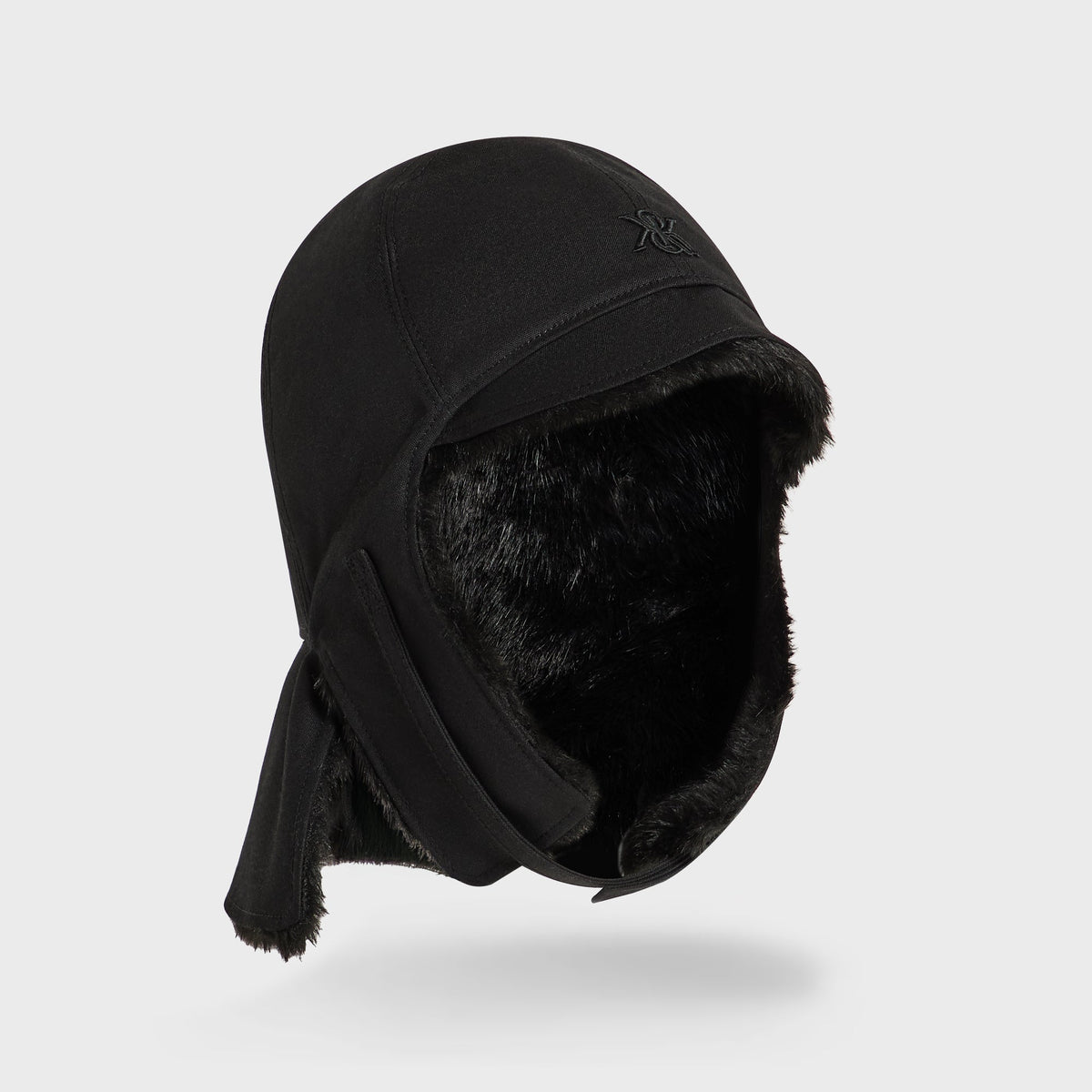 Kith Shearling Lined Waxed Canvas Trapper Hat in black, angled view with earflap down