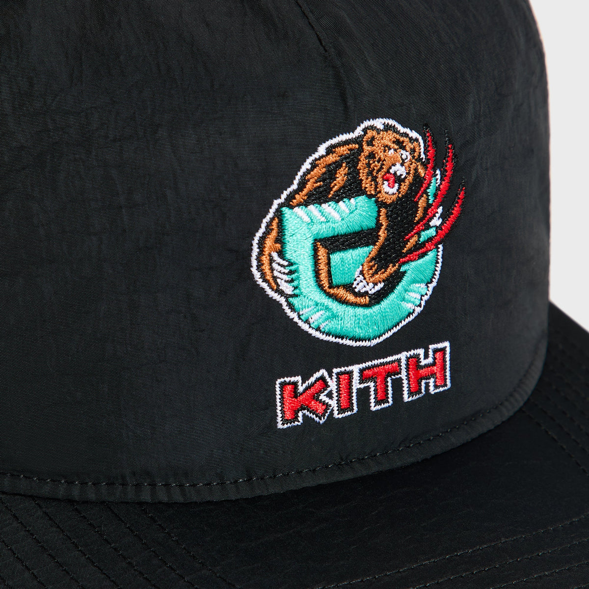 Kith & '47 for the Vancouver Grizzlies SL Hitch Snapback Cap close-up of embroidered Grizzlies bear G logo and red Kith text on black nylon