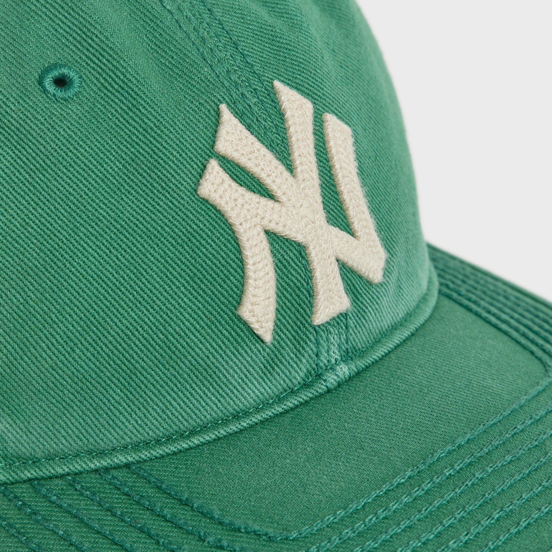 Close-up of cream NY logo embroidery on Kelly Heavy Twill Franchise LS Cap