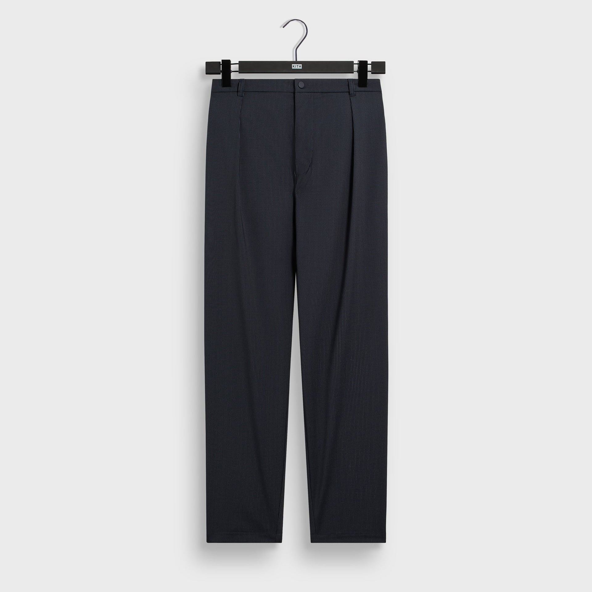&Kin Tropical Wool Idris Pant in Nocturnal navy pinstripe, front view on KITH hanger, pleated