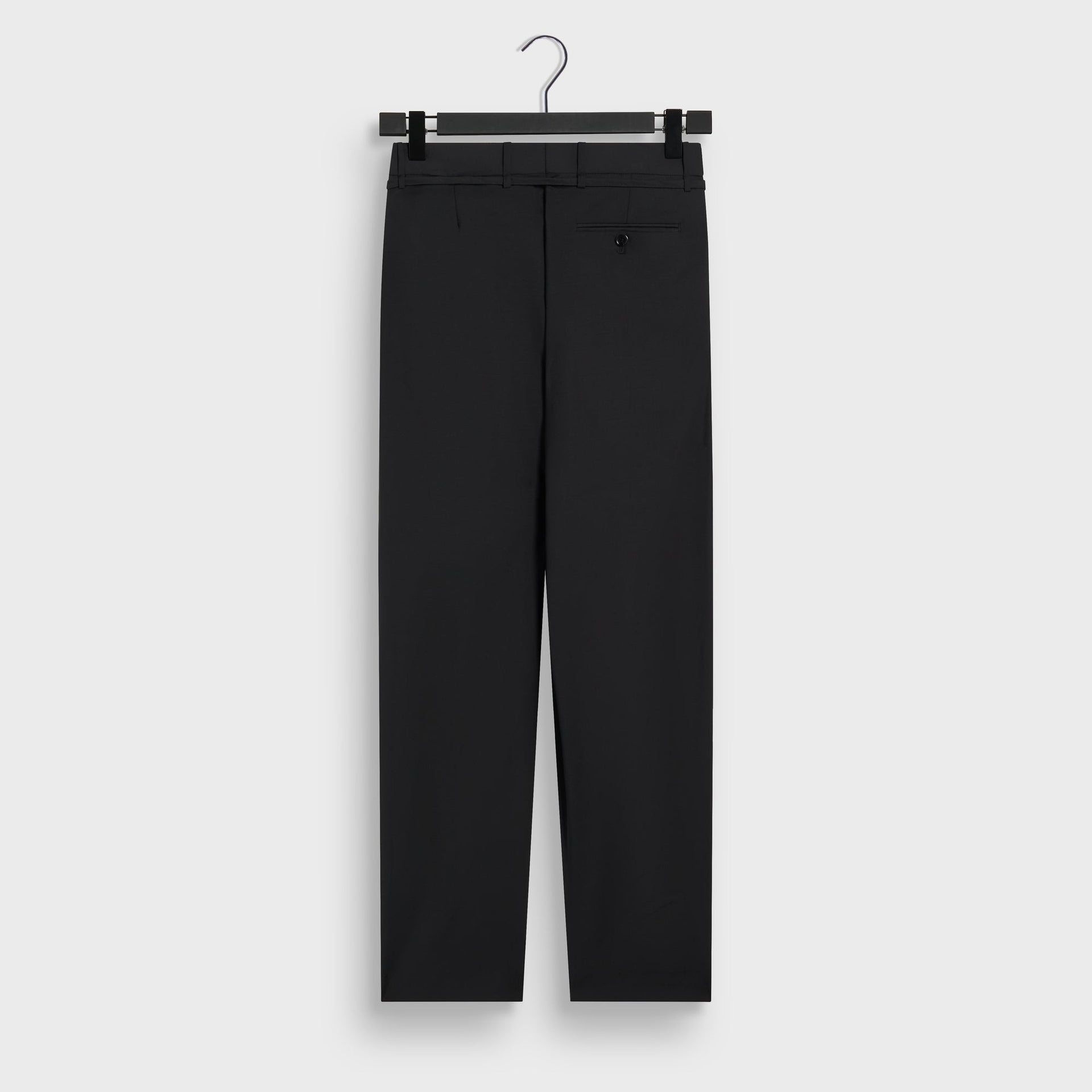 &Kin Eli Pleated Trouser in Black, back view on hanger with welt back pocket and belt loops