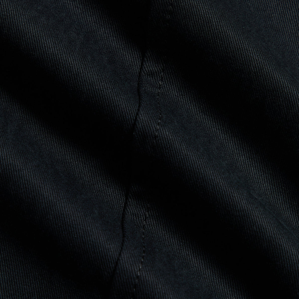 Kith Washed Herringbone Twill Gus Pant in black, macro close-up of twill fabric texture and stitched seam
