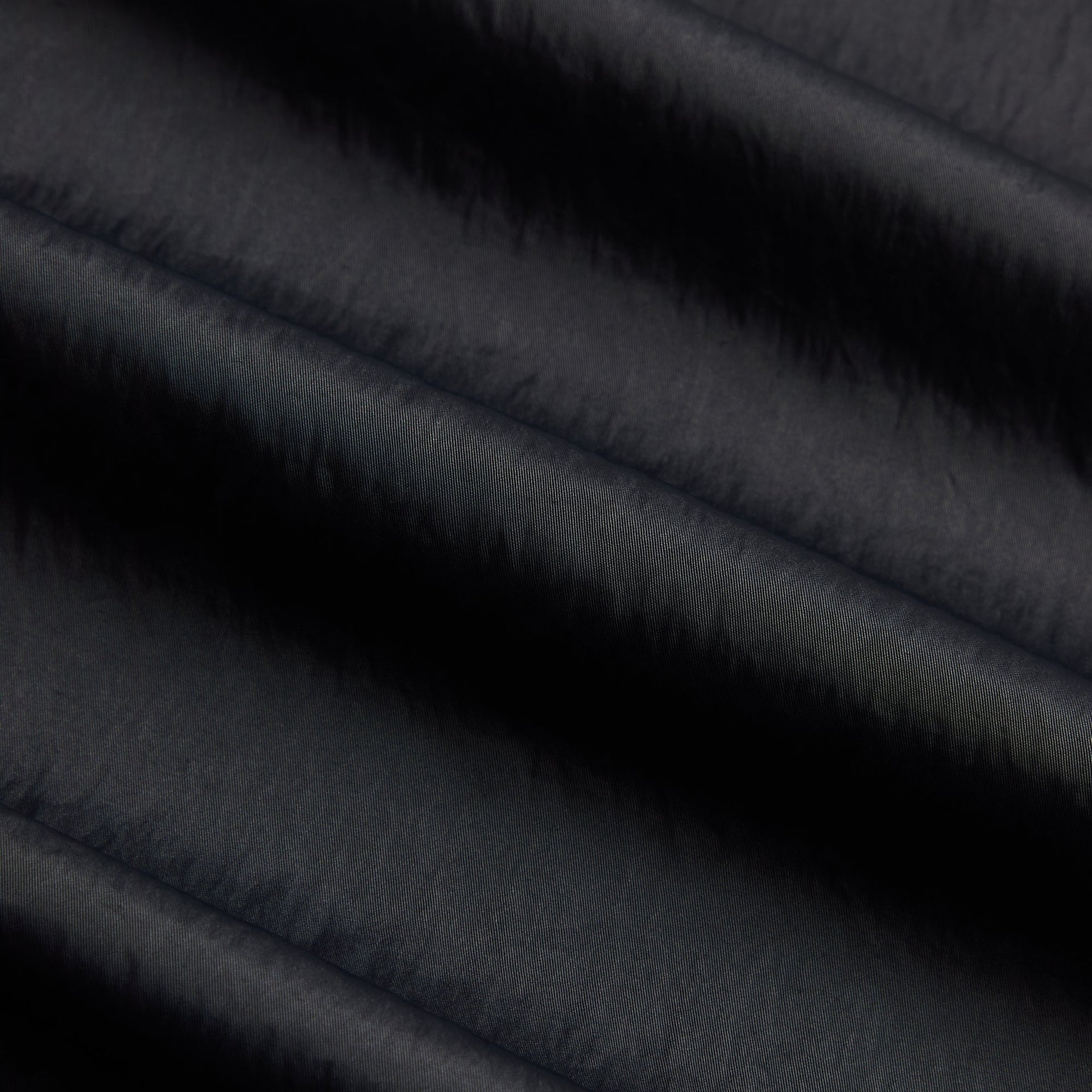 Close-up of the black nylon fabric texture on the Kith Maverick pant
